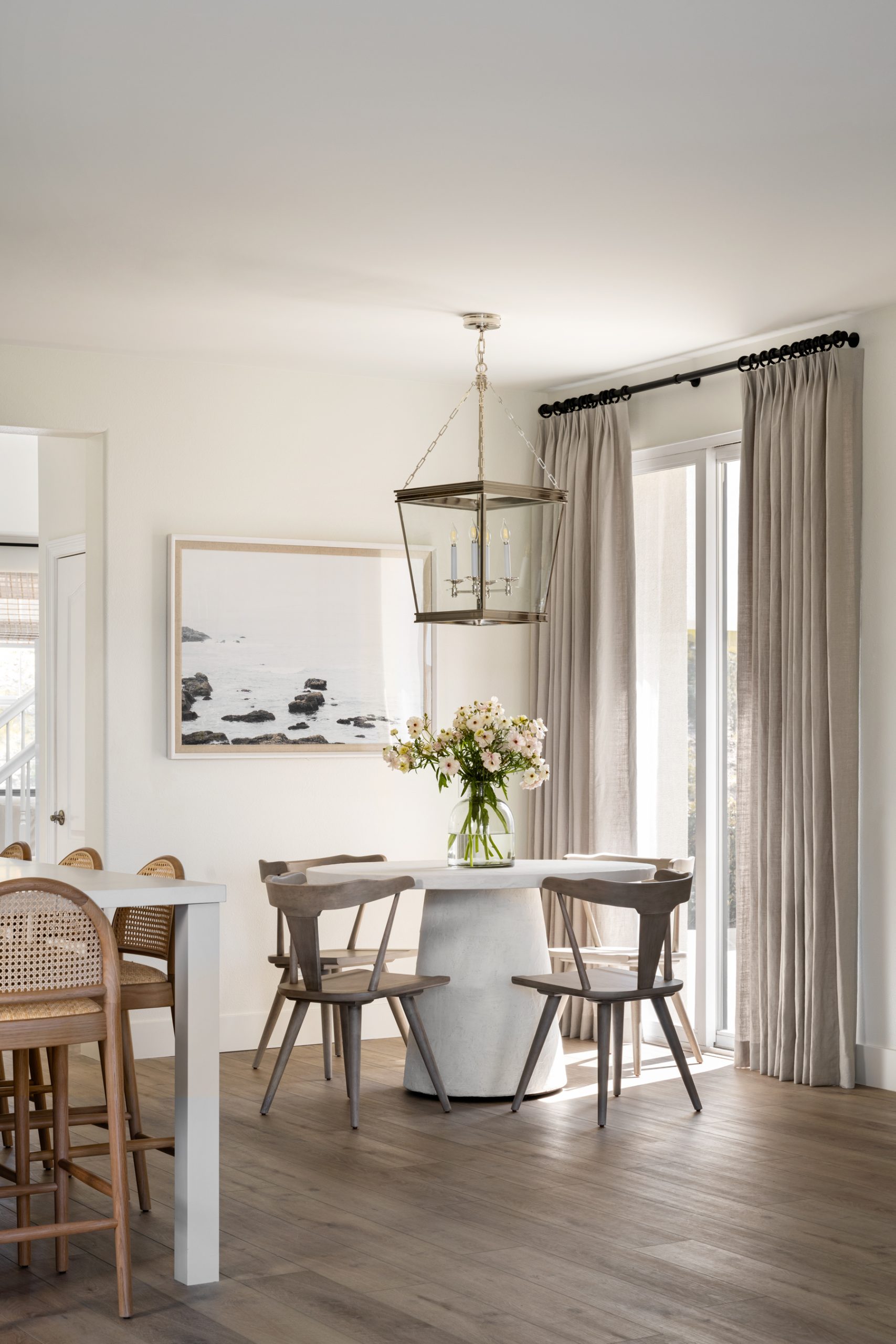 dining nook with white table and brown chairs