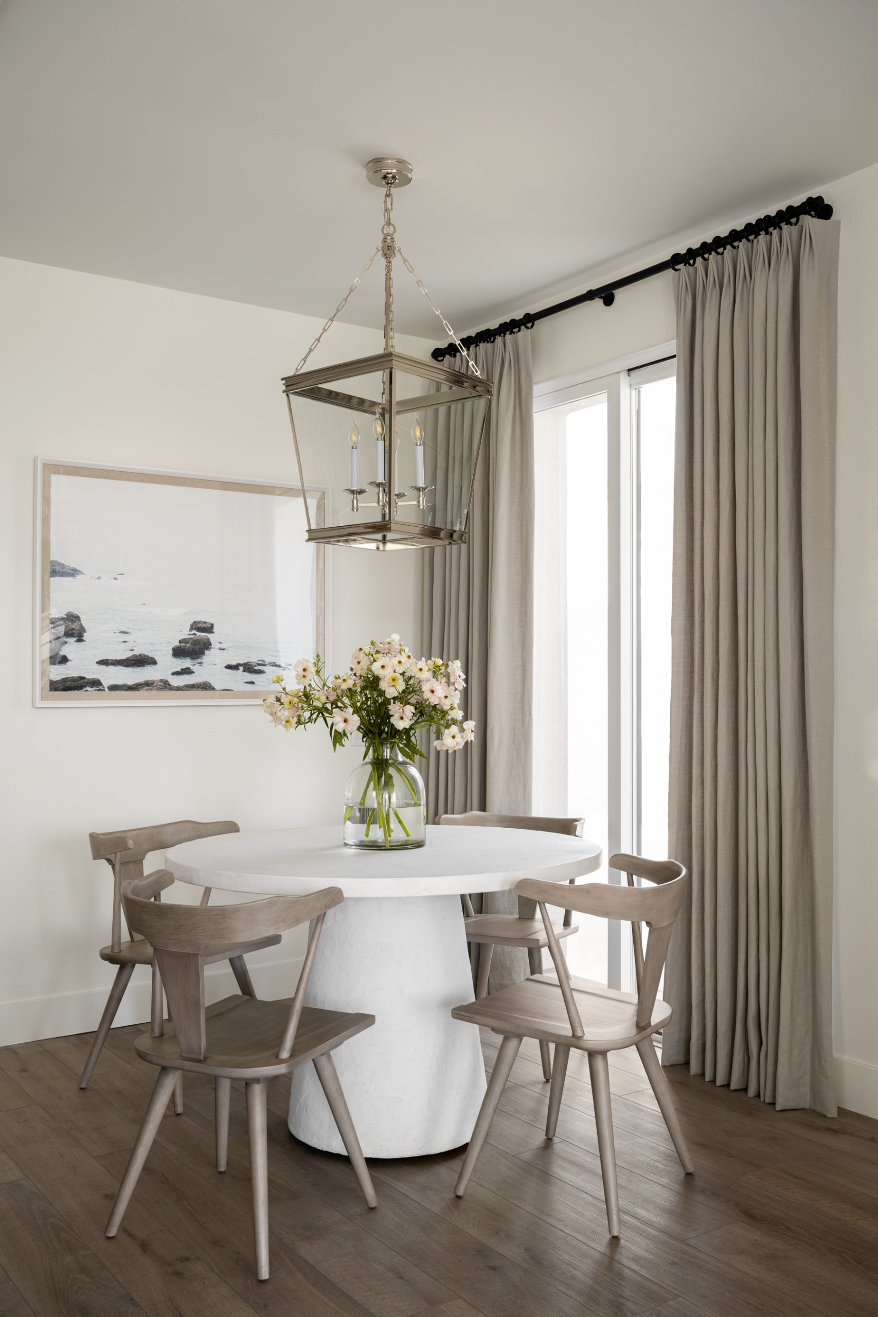 dining nook with white table and brown chairs