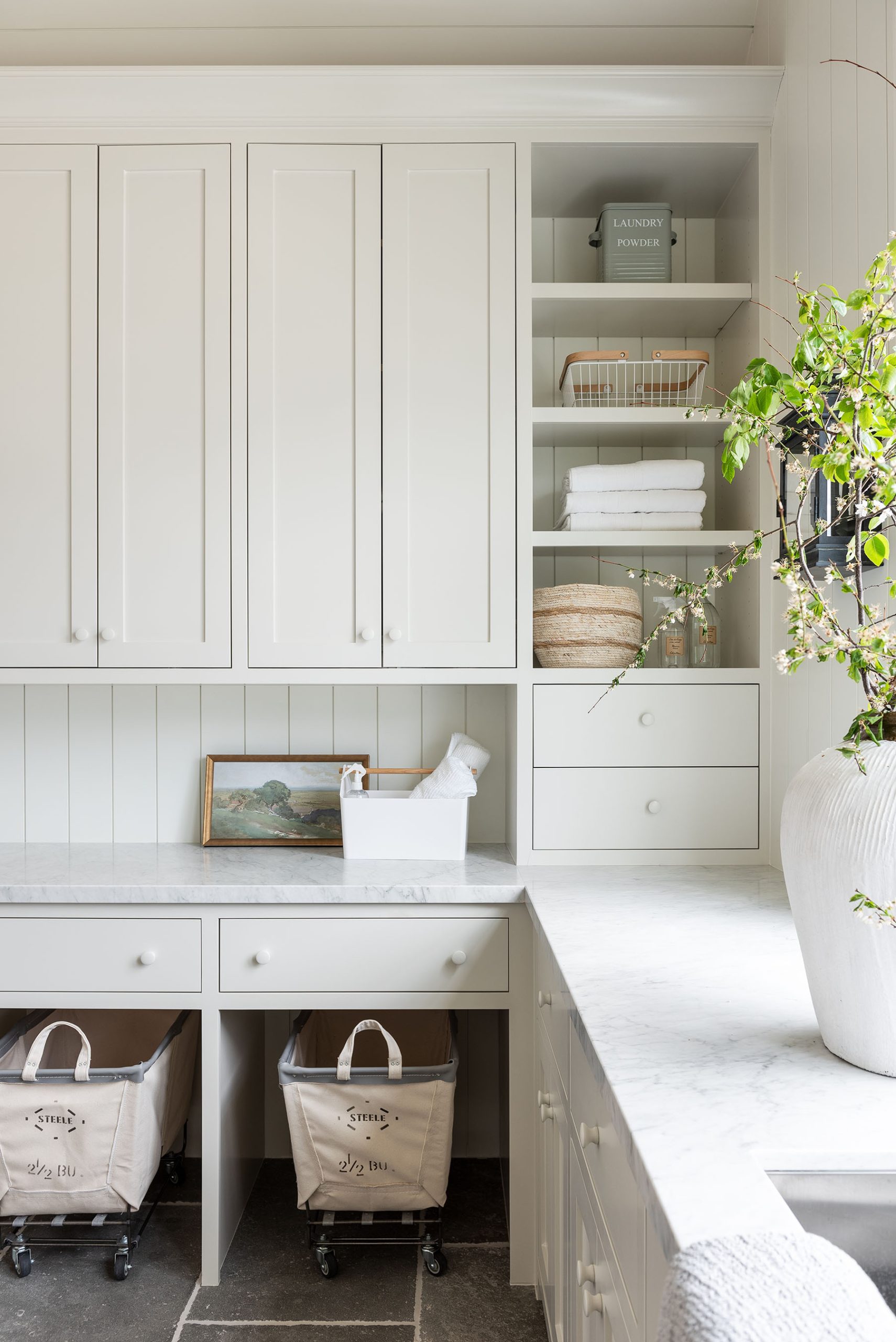 laundry room with white countertops and white cabinetry