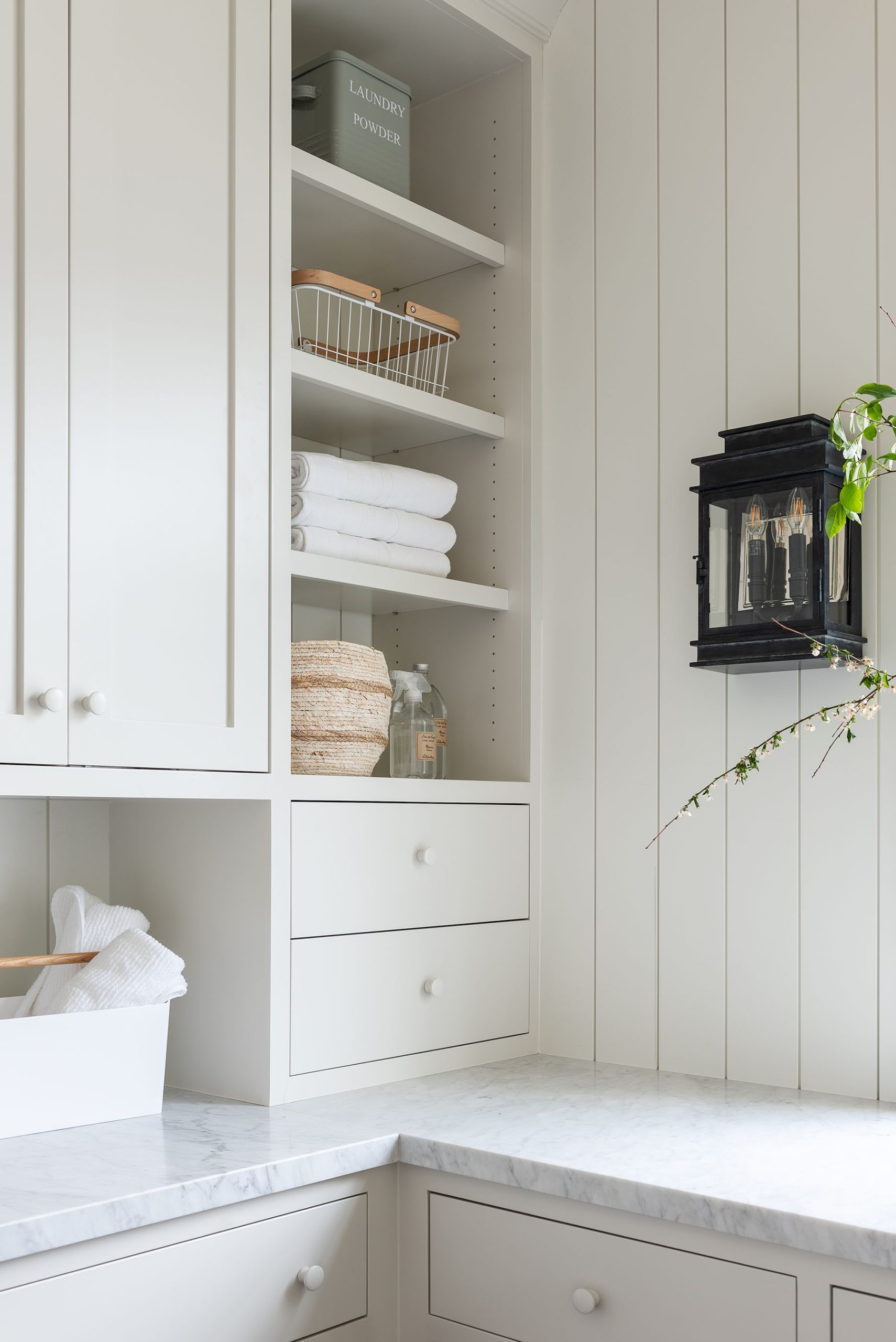 laundry room with white countertops and white cabinetry