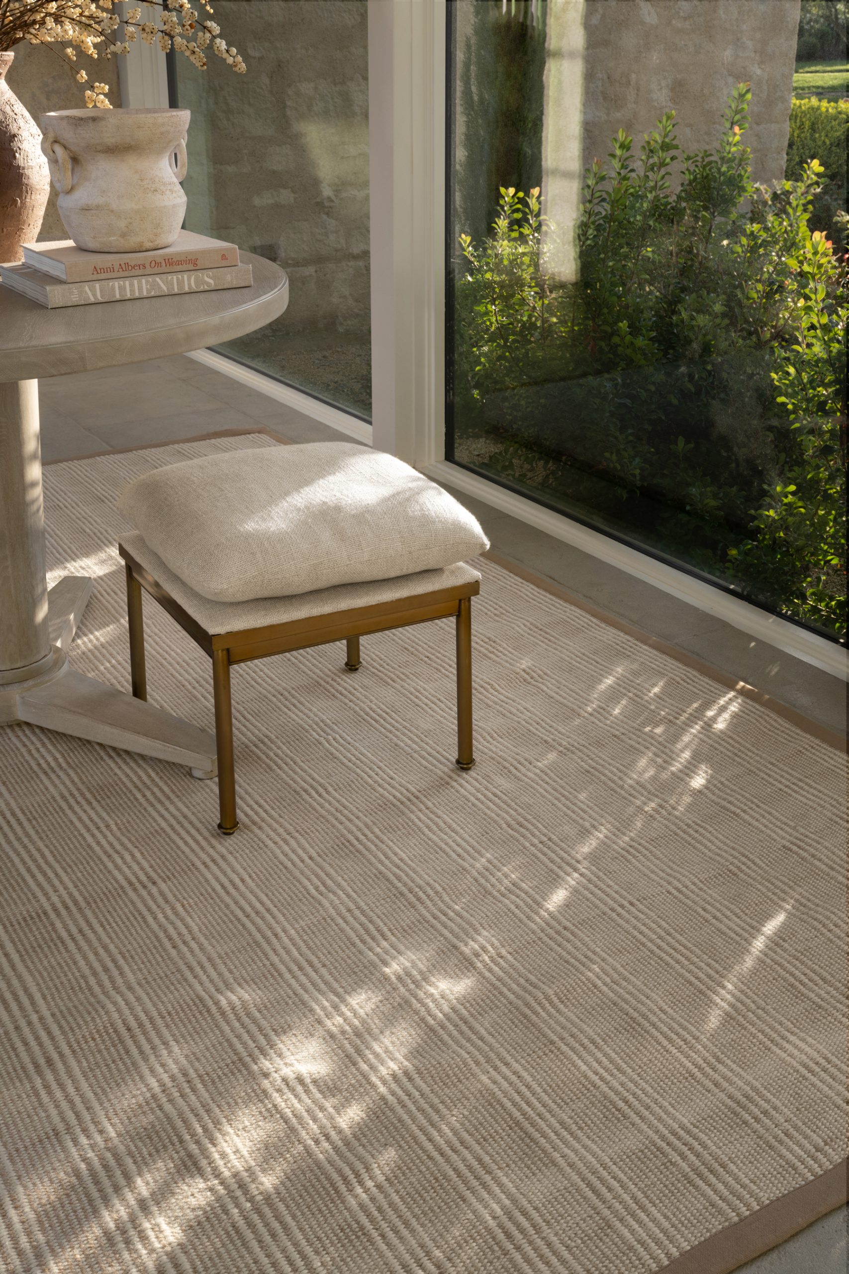 indoor/outdoor rug in entryway with ottoman