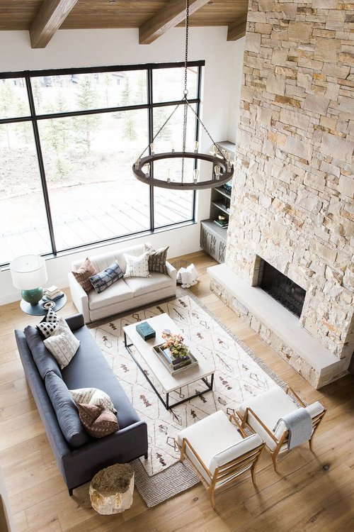 Great+room+with+dramatic+stone+fireplace,+layered+rugs,+and+neutral+color+scheme.jpg