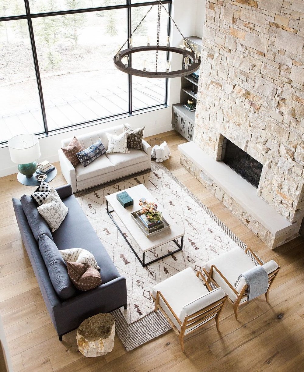 Great+room+with+dramatic+stone+fireplace,+layered+rugs,+and+neutral+color+scheme.jpg