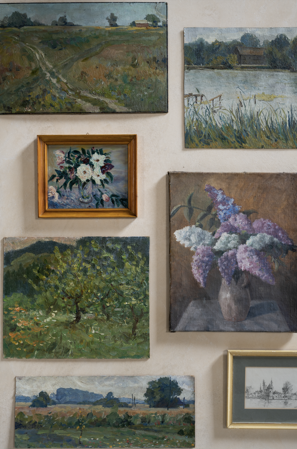 landscape and floral artwork in gallery wall