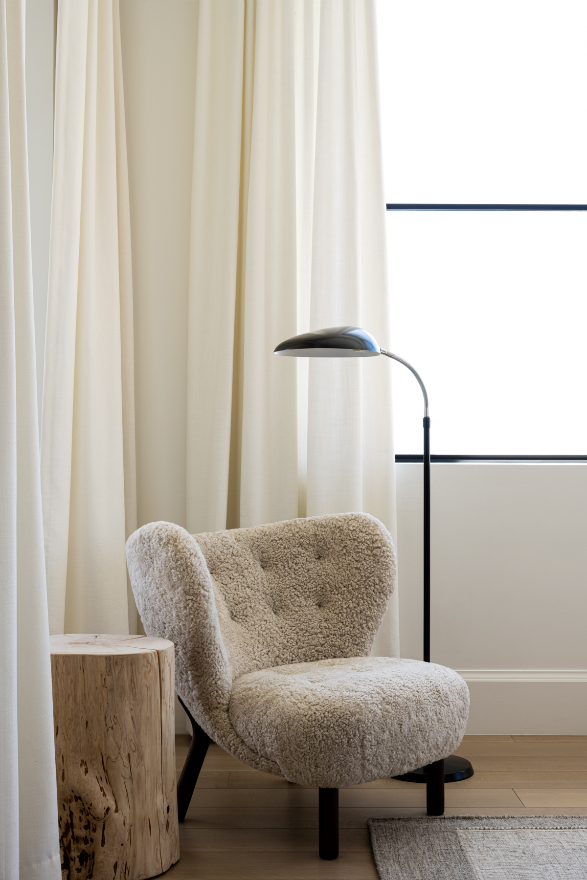 curved boucle chair and wood side table