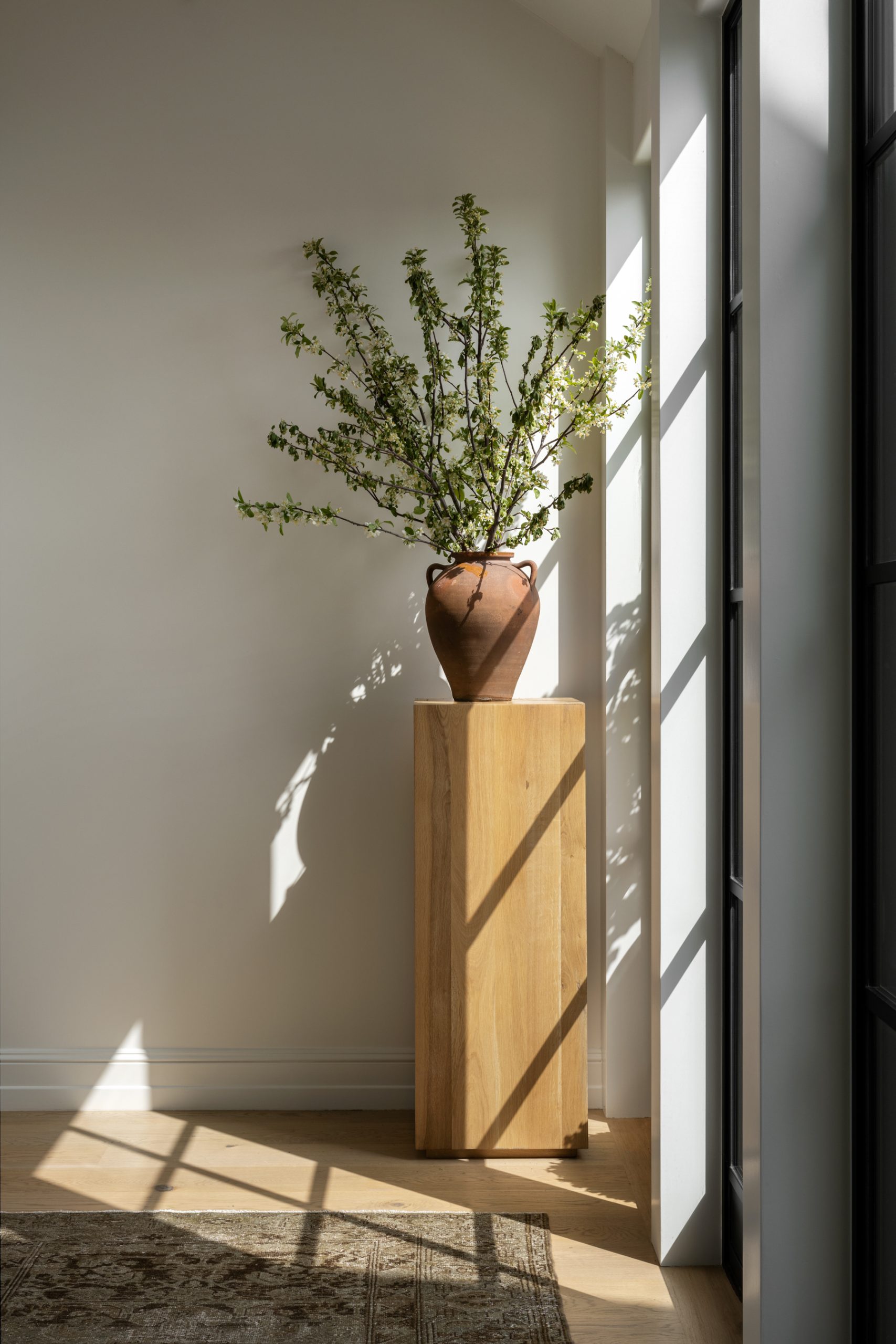 Pedestal in hallway of windows