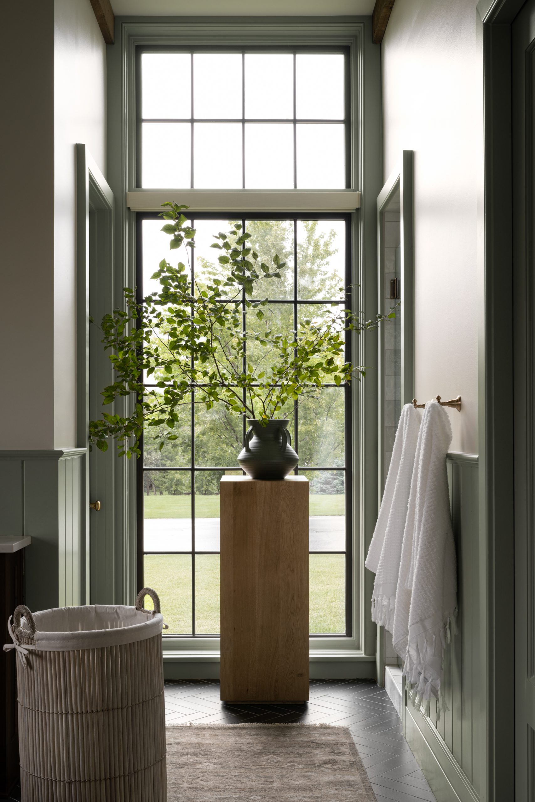Wood pedestal in bathroom with windows