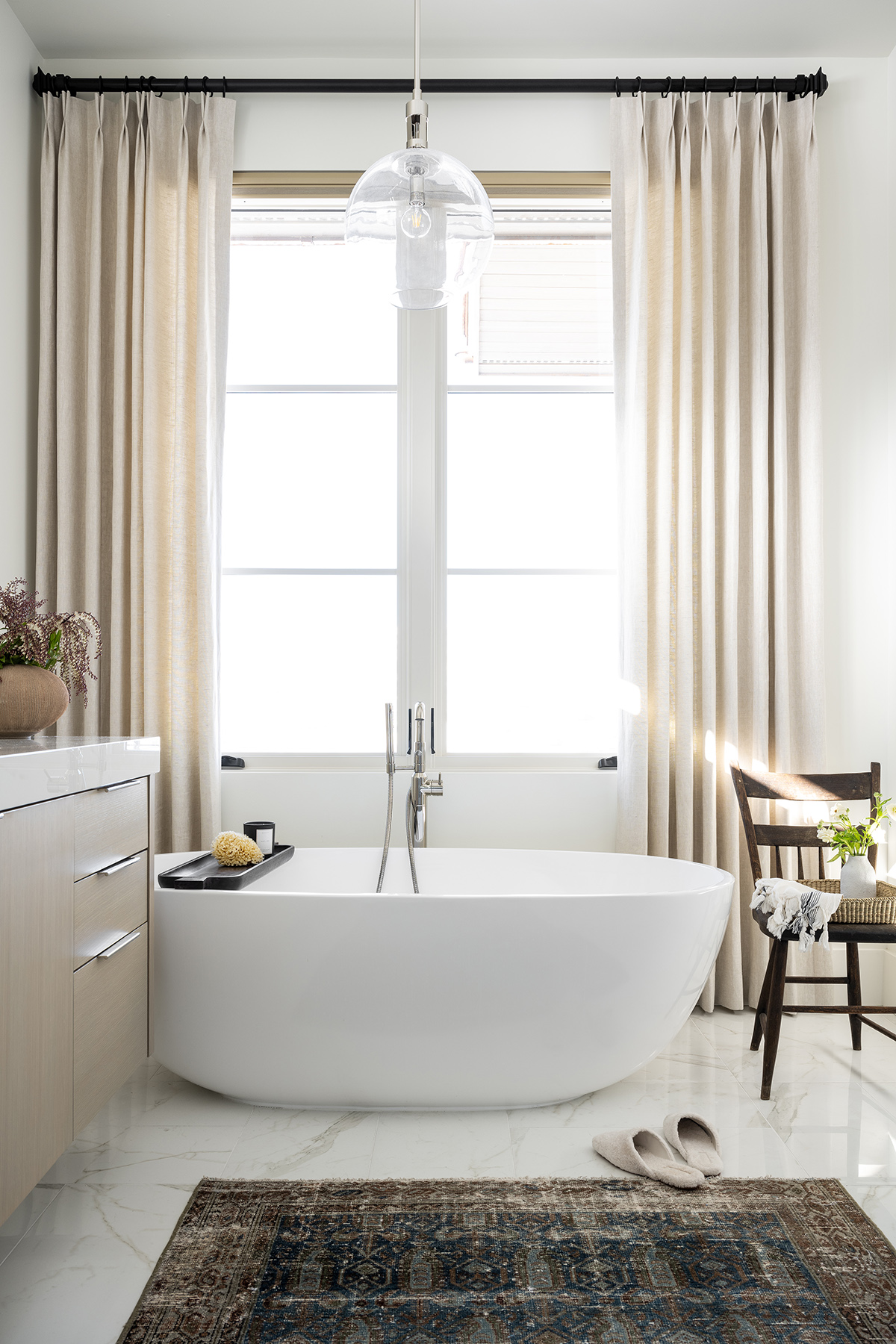 standing bathtub in front of large window