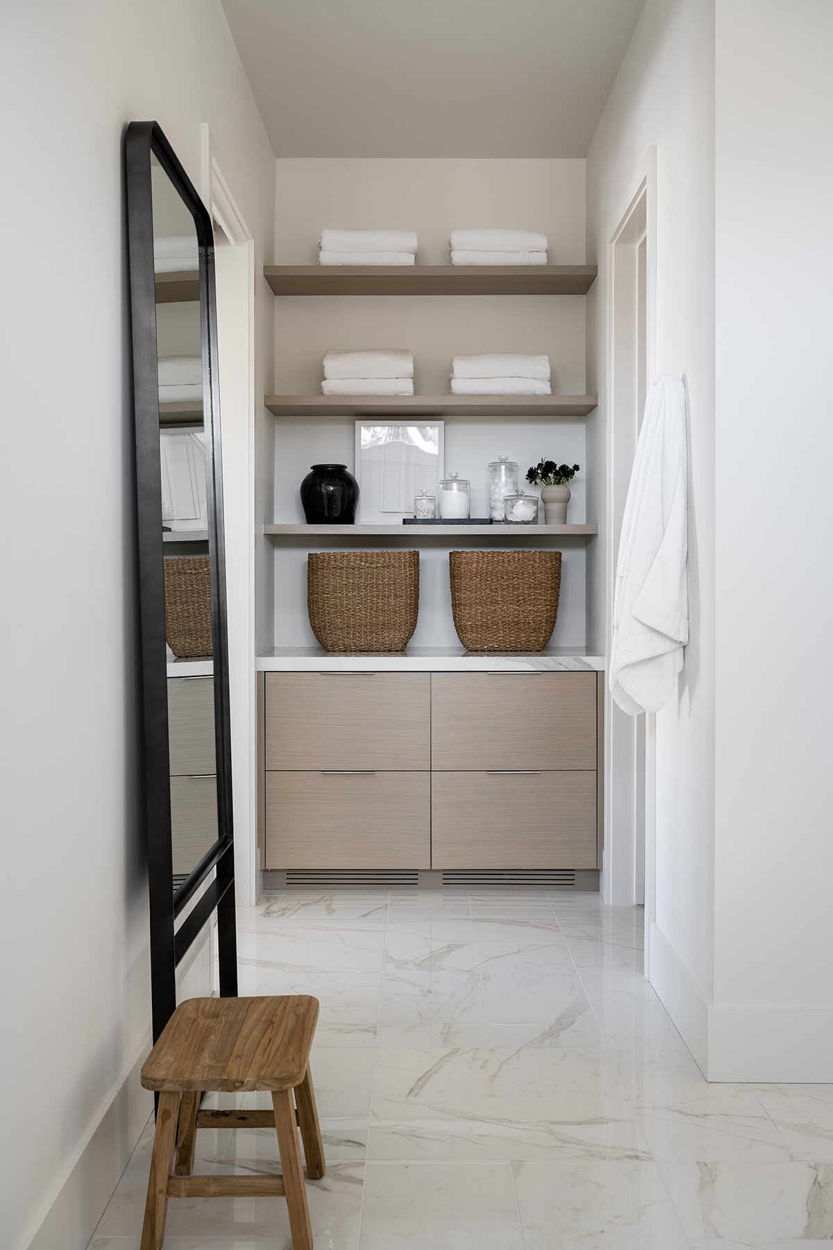 white bathroom with wood cabinetry