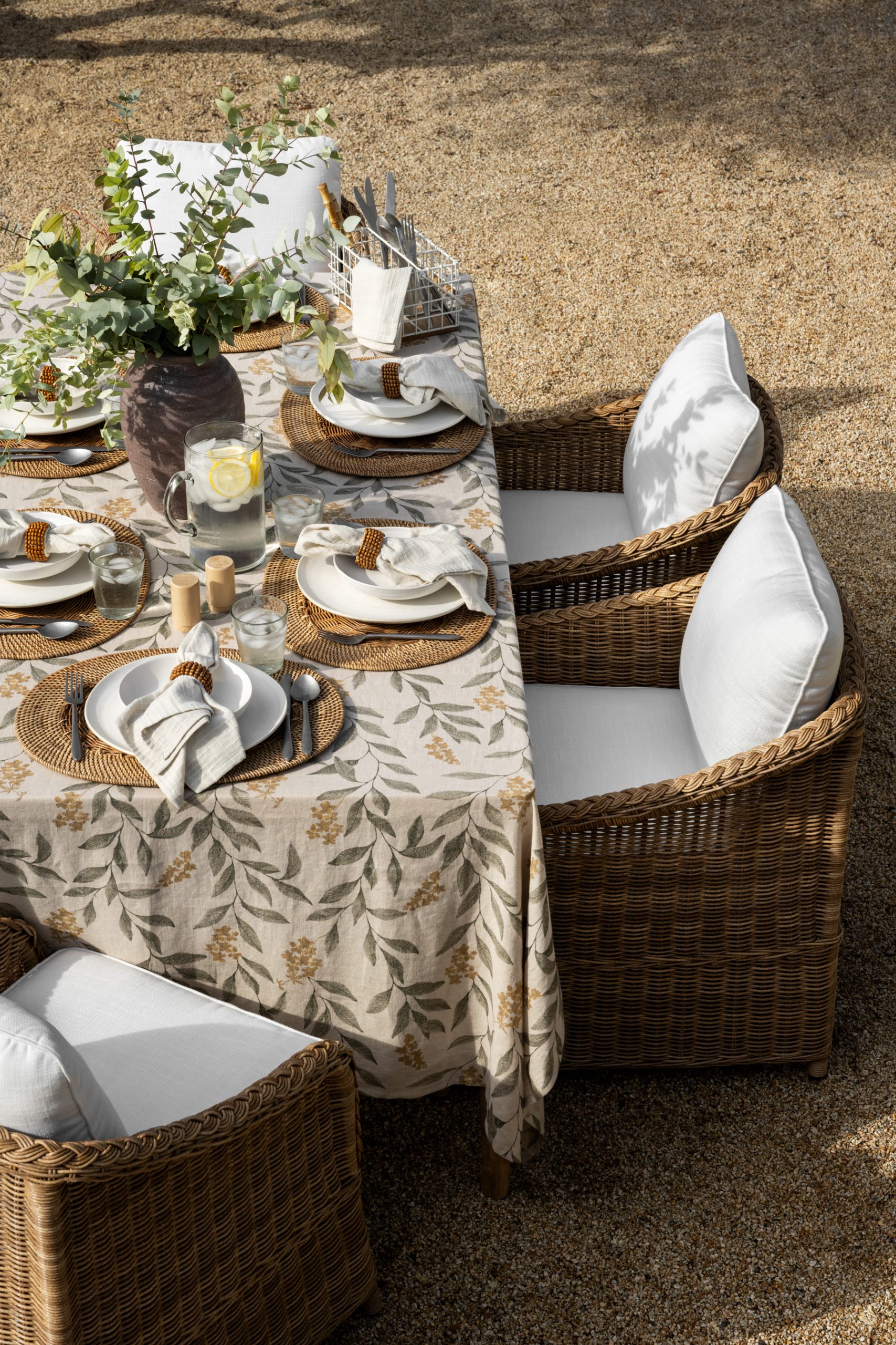 wicker outdoor dining chair around outdoor tablescape