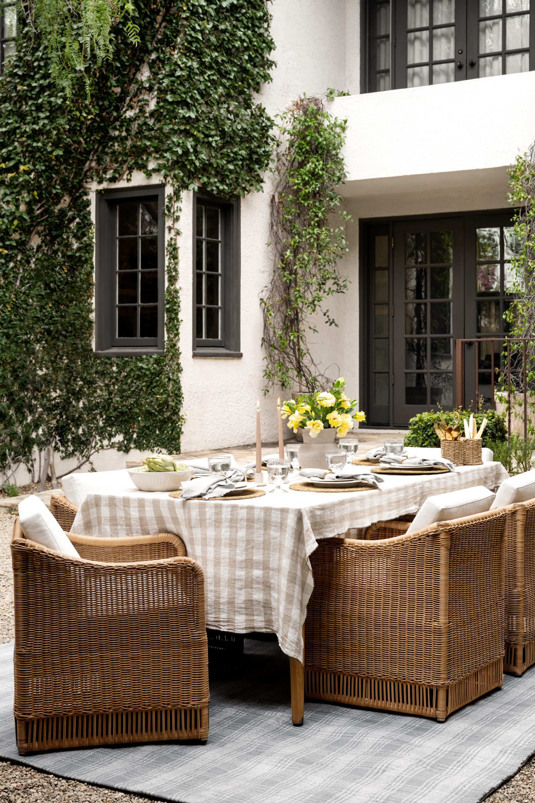 outdoor tablescape wicker outdoor dining chairs with gingham tablecloth
