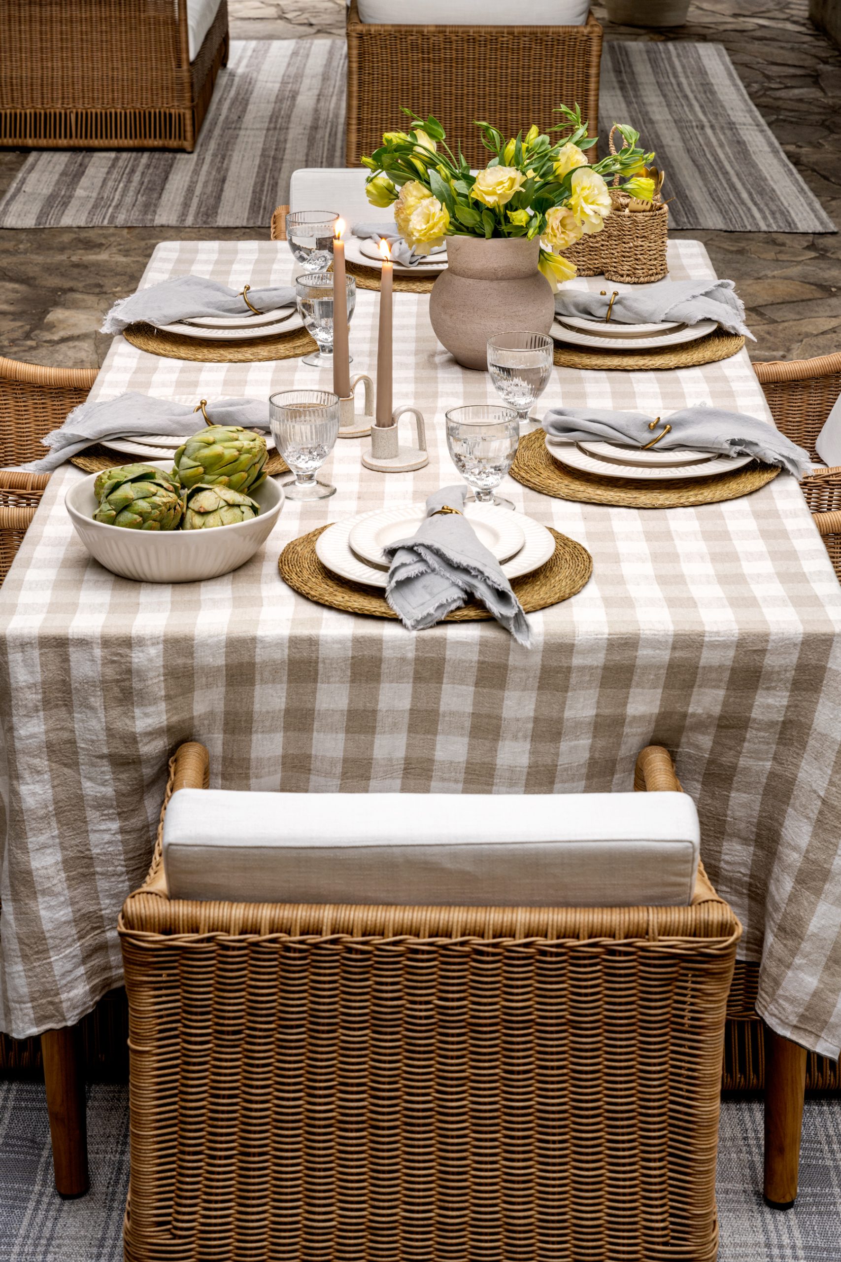 outdoor tablescape wicker outdoor dining chairs with gingham tablecloth