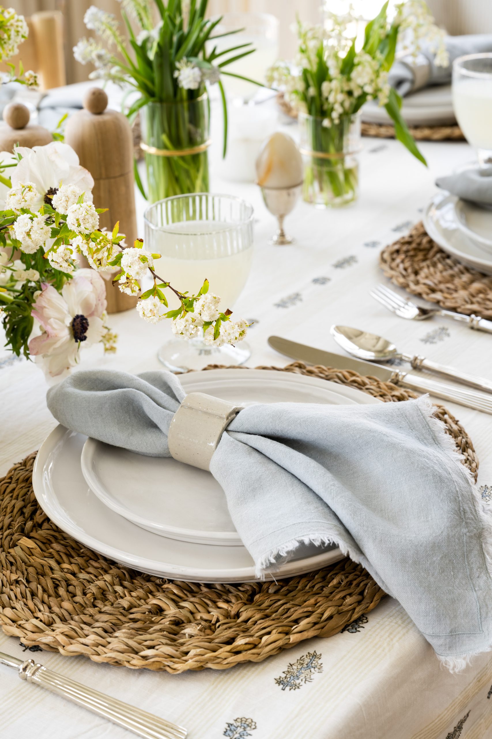 white ribbed plate on seagrass placemat on tan floral tablecloth