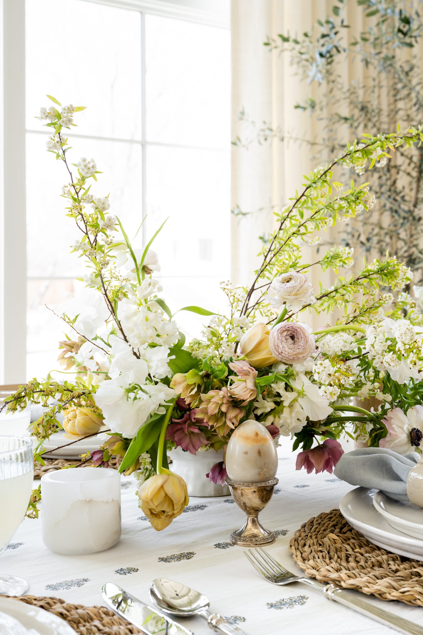 Easter tablescape with floral arrangement and egg in egg cup