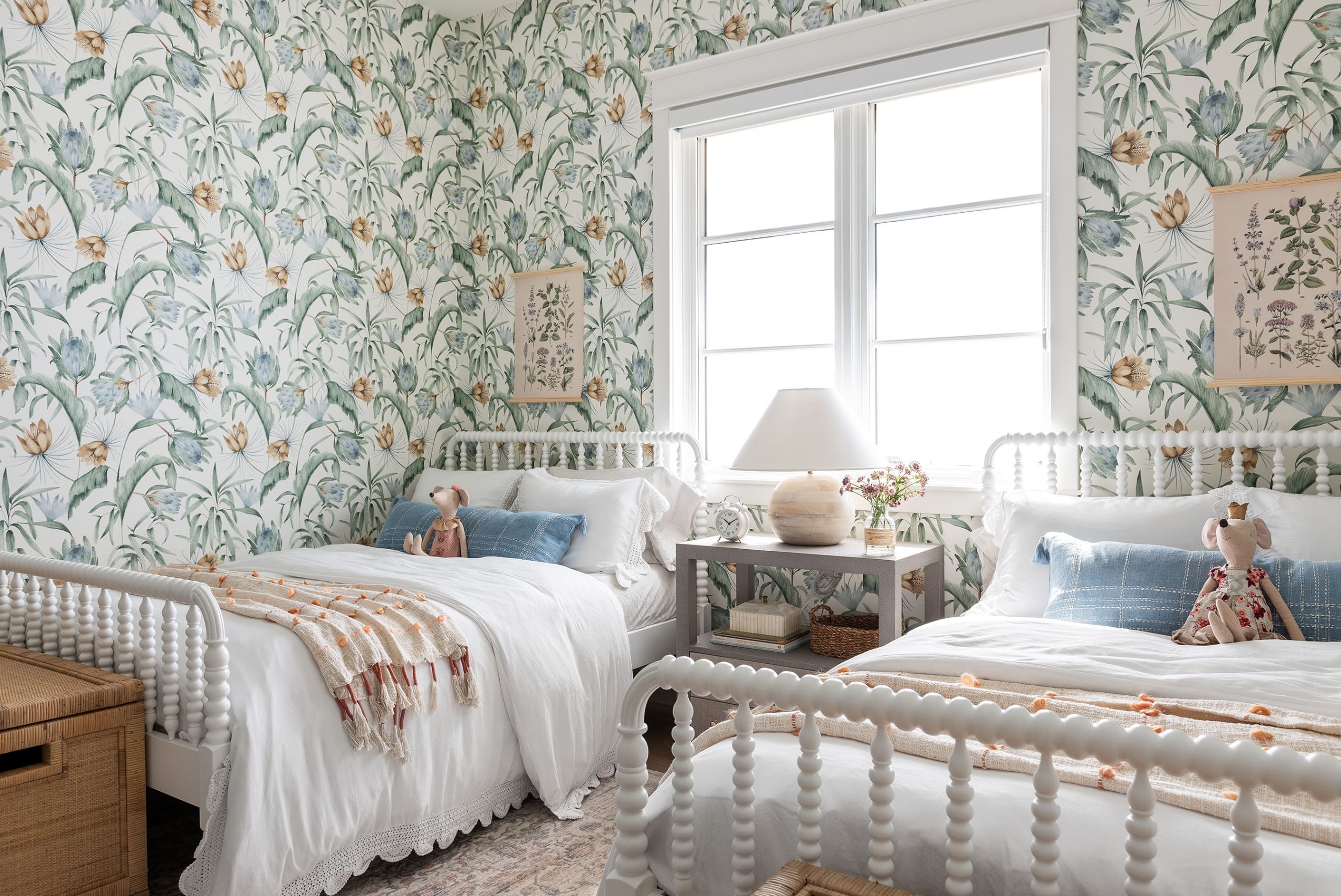 bedroom with green floral wallpaper and two white twin beds