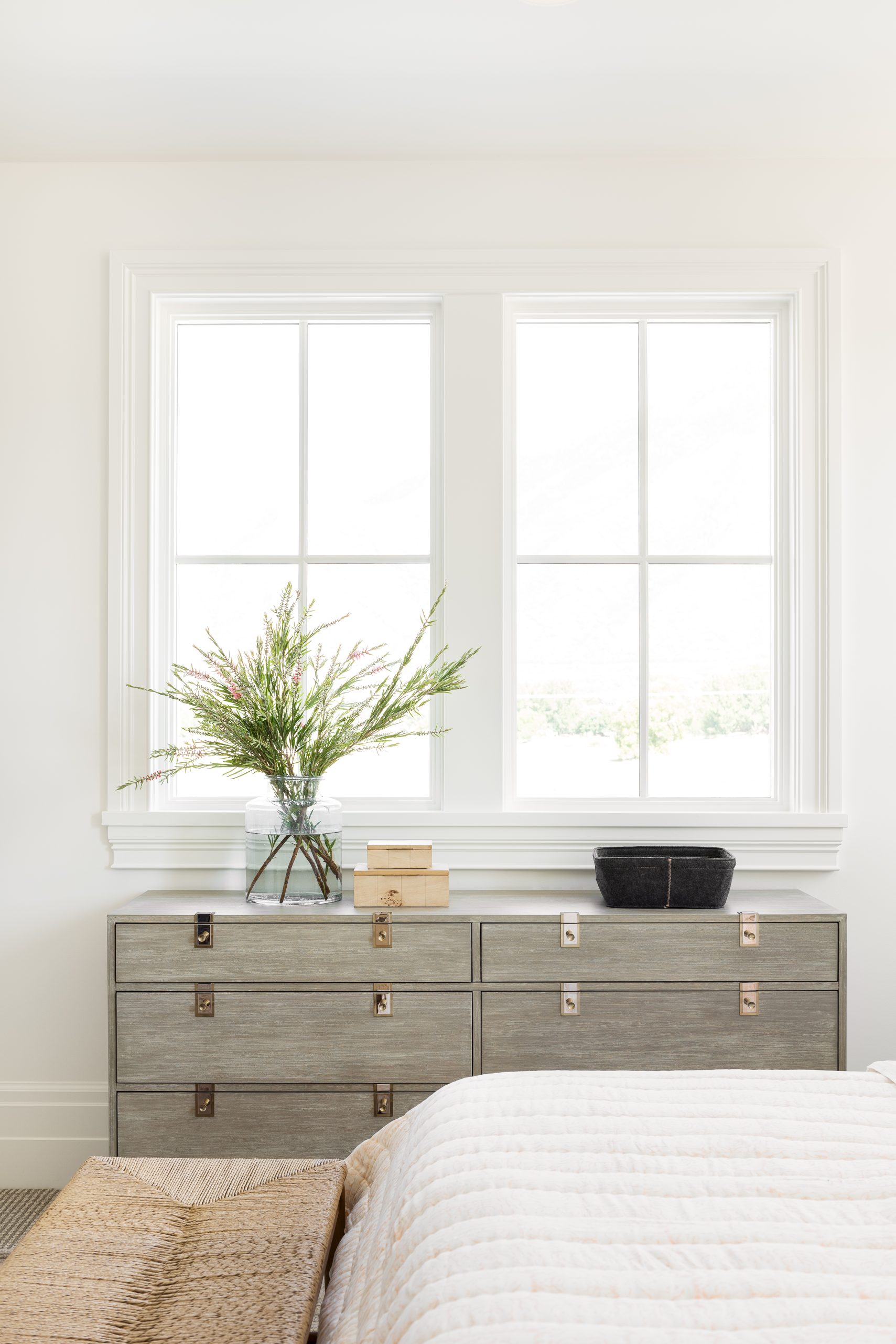 white bedroom with gray dresser