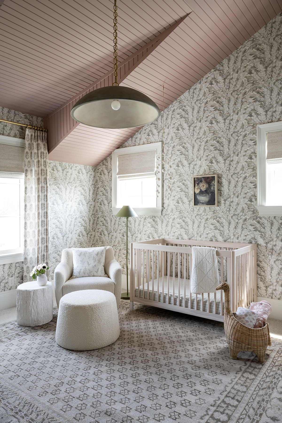 nursery with floral wallpaper and pink ceiling