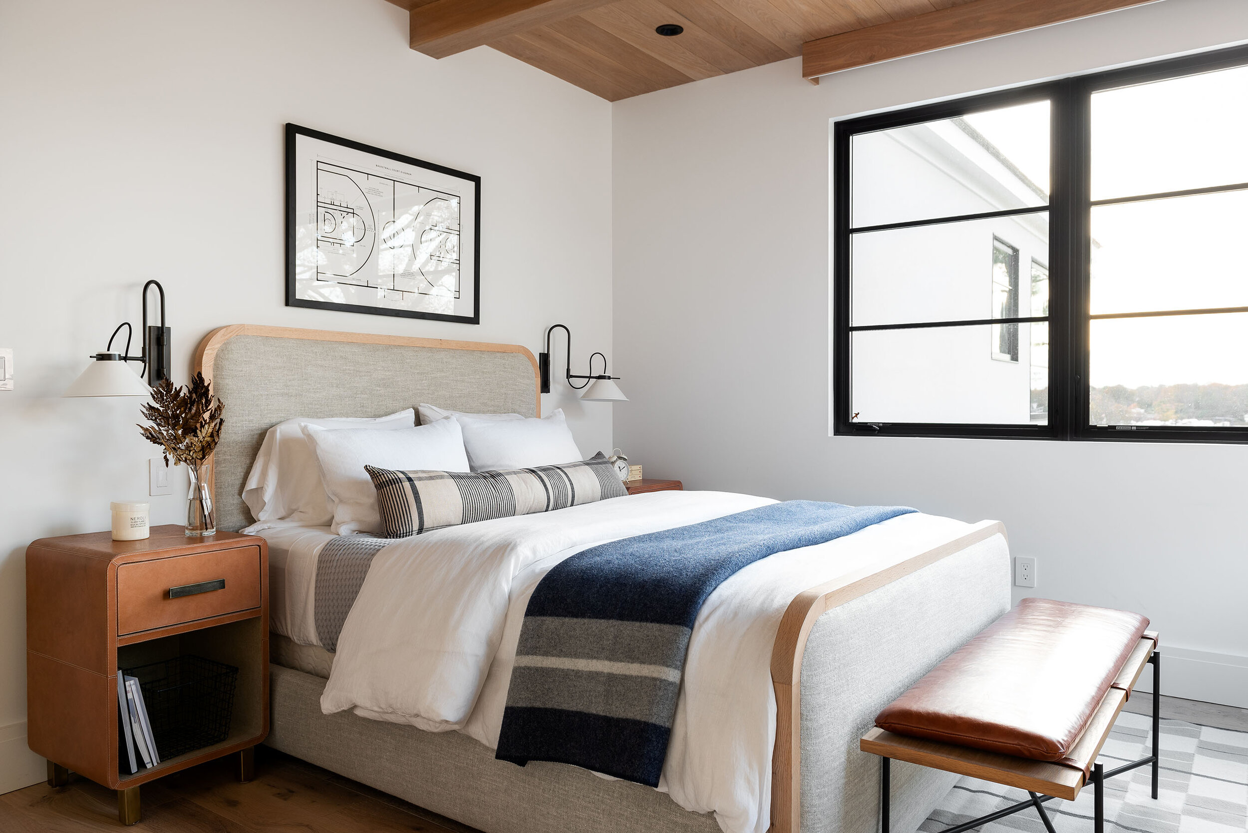 bedroom with grey upholstered bed with wood nightstands