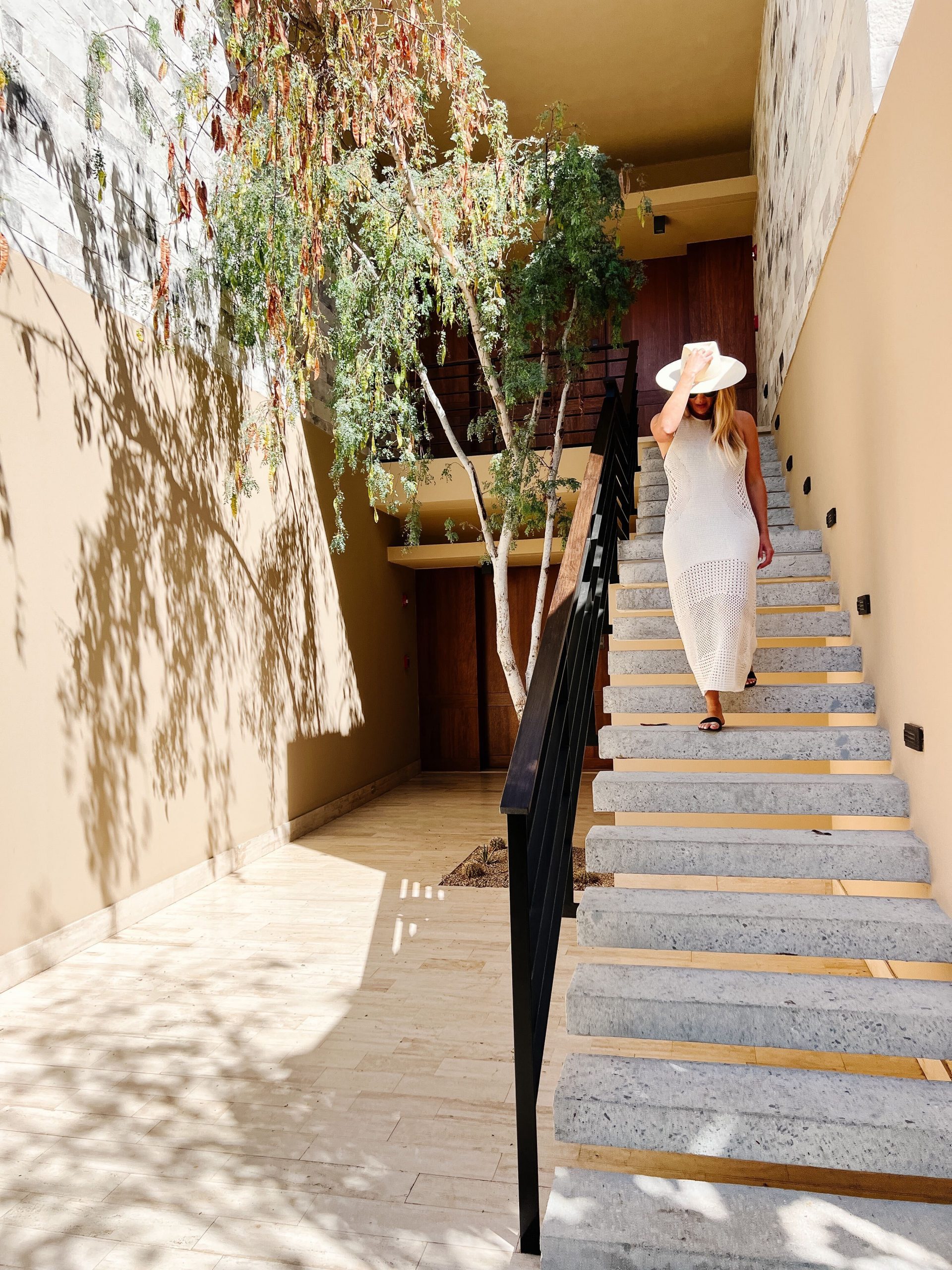 Shea walking town stairs in Cabo