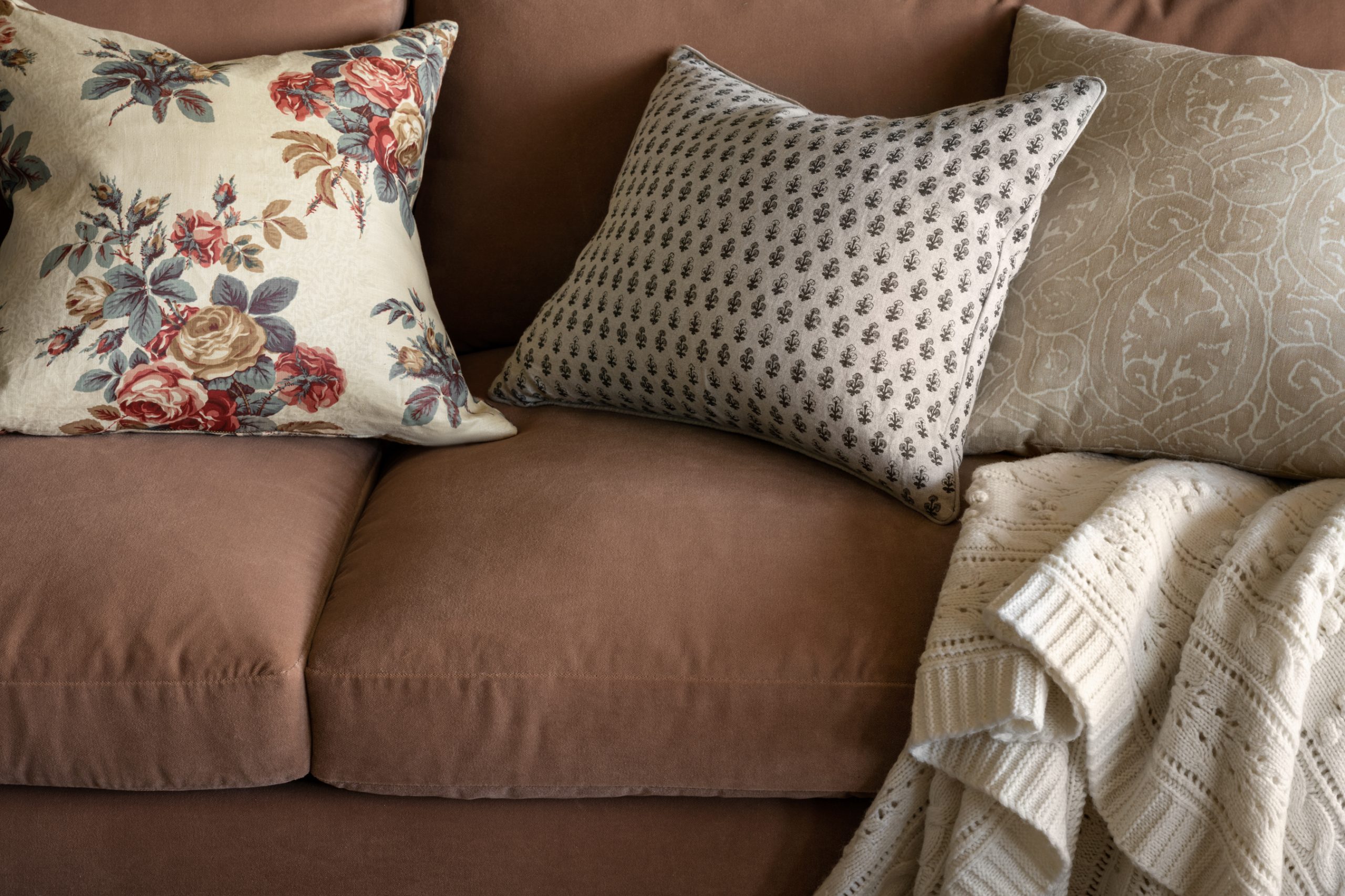 velvet couch with patterned pillows