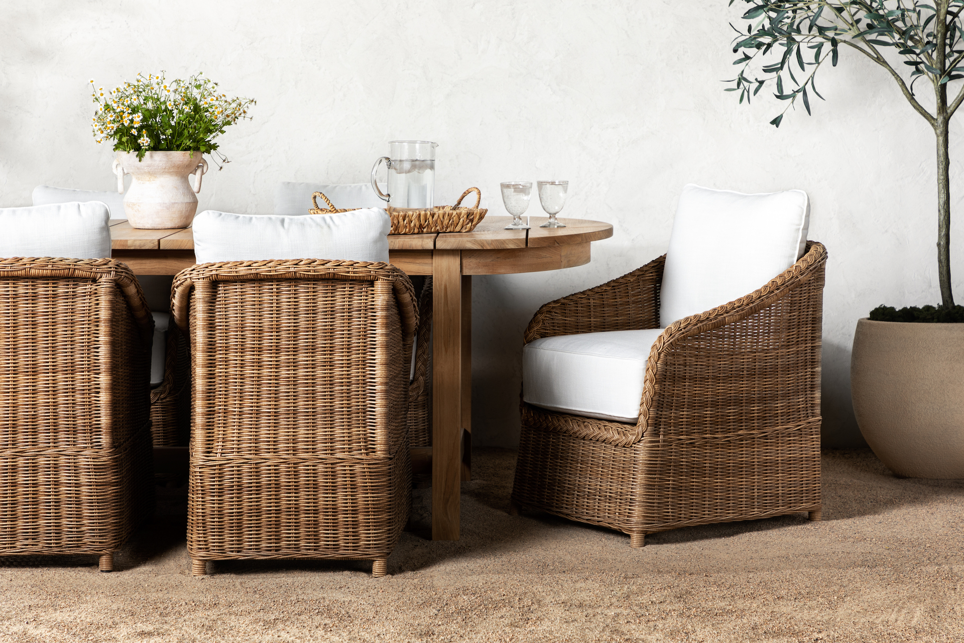 wicker dining chairs around teak wood dining table