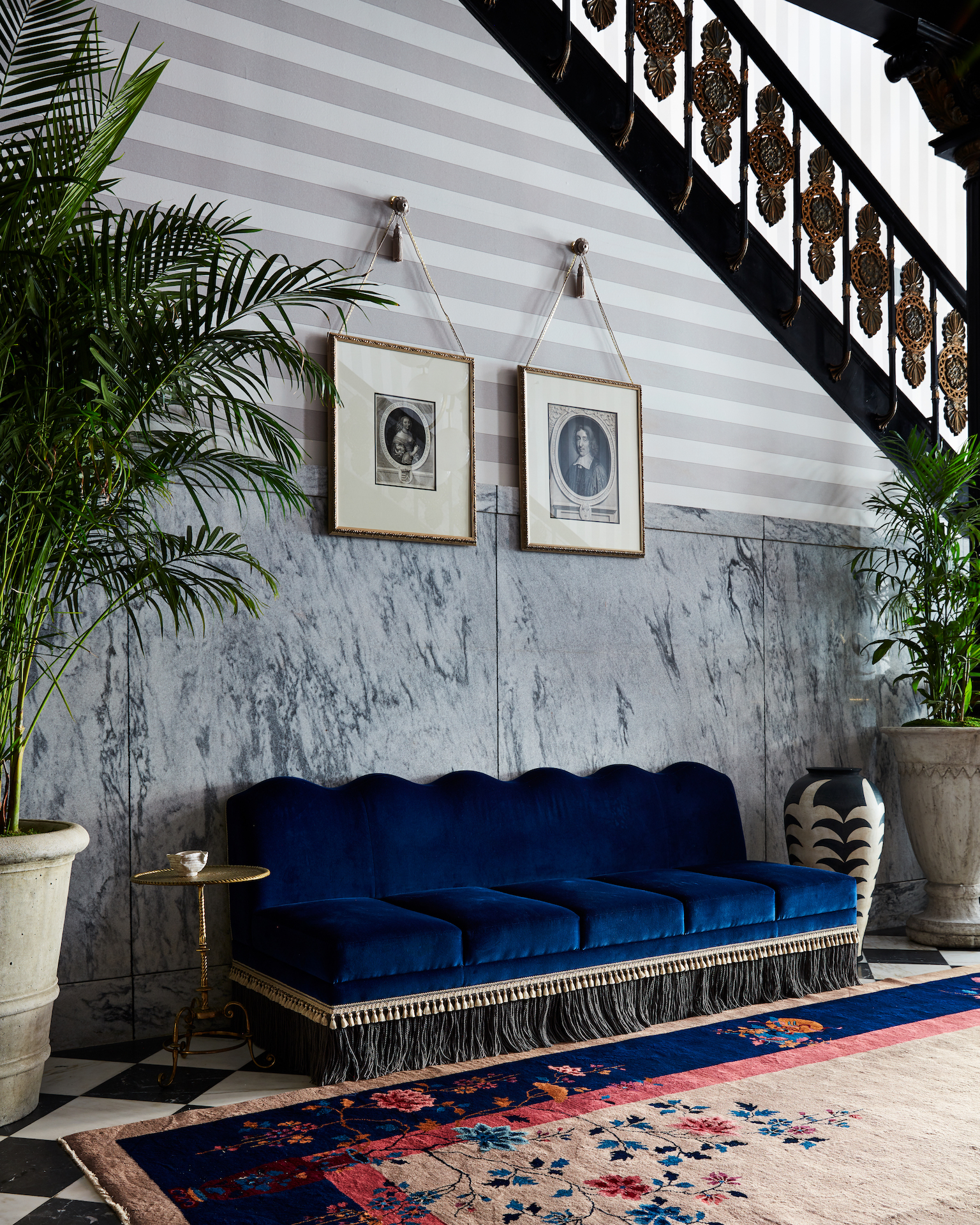 Maison de la Luz hallway with blue sofa and artwork hanging above