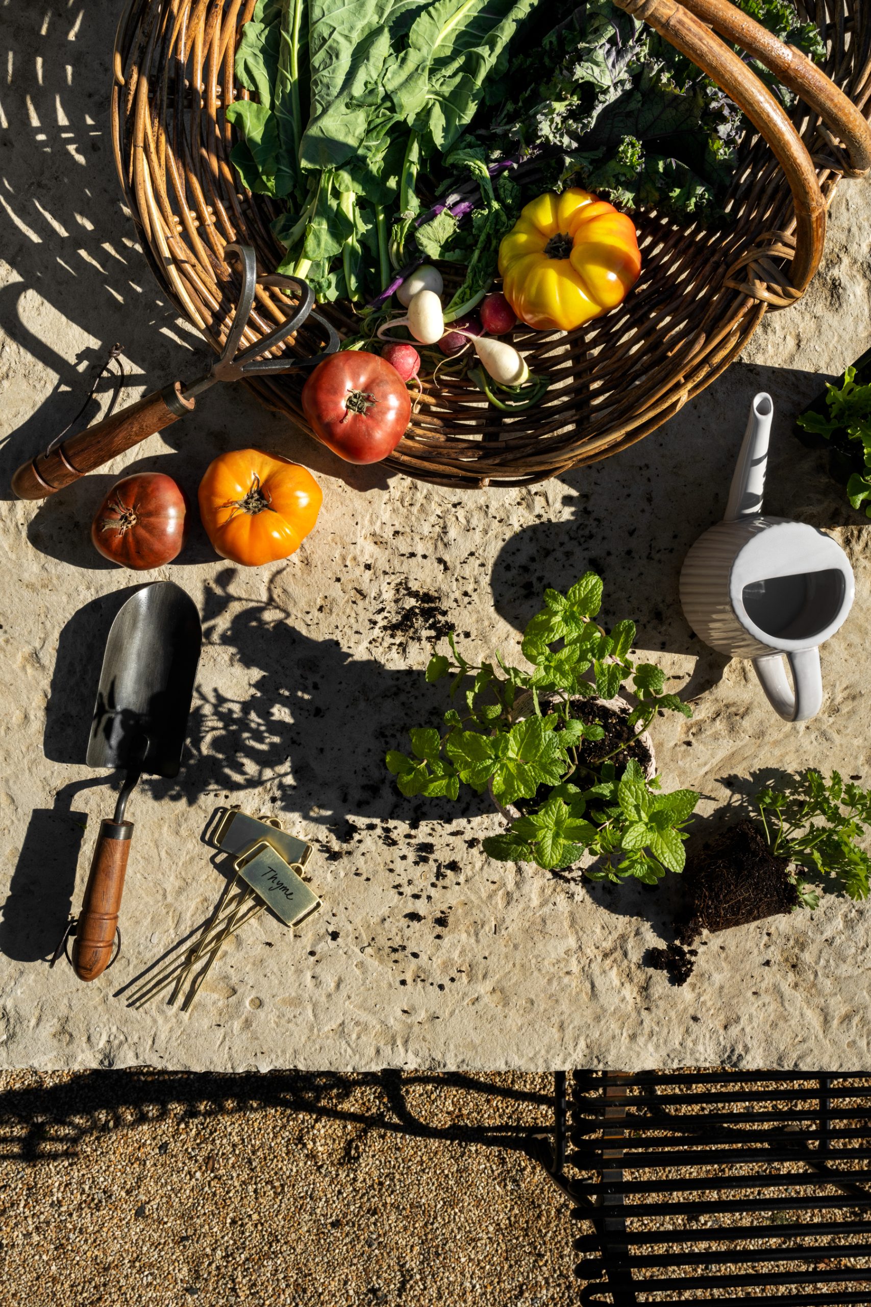 rattan basket with vegetables and gardening shovel and watering can