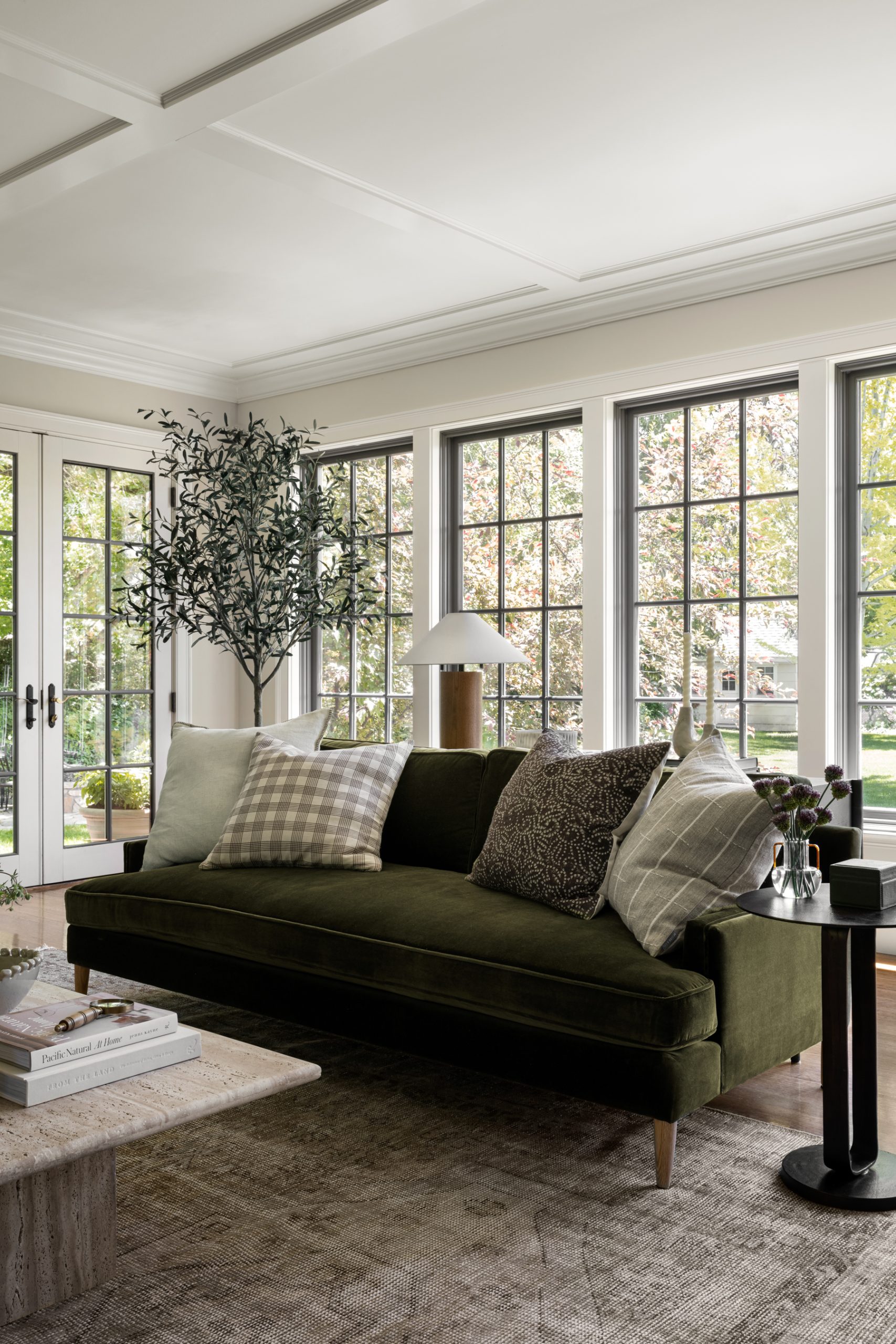 living room with green velvet sofa