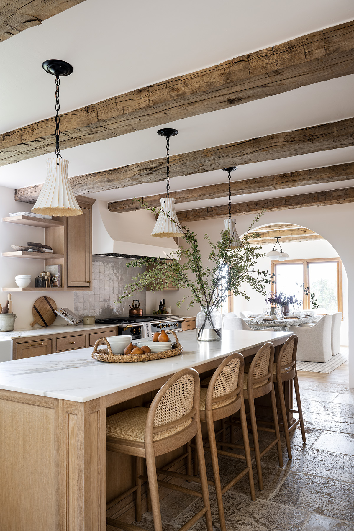 kitchen with natural wood cabinets and rattan oak counter stools