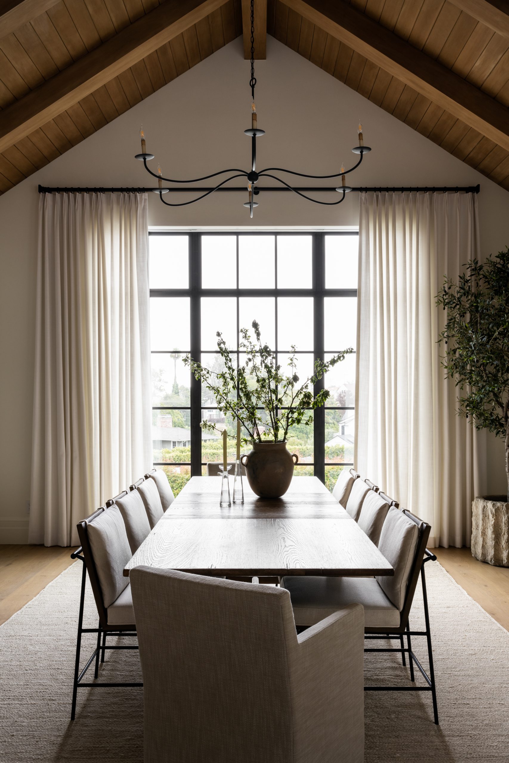 dining room with wooden table and metal chairs with white cushions