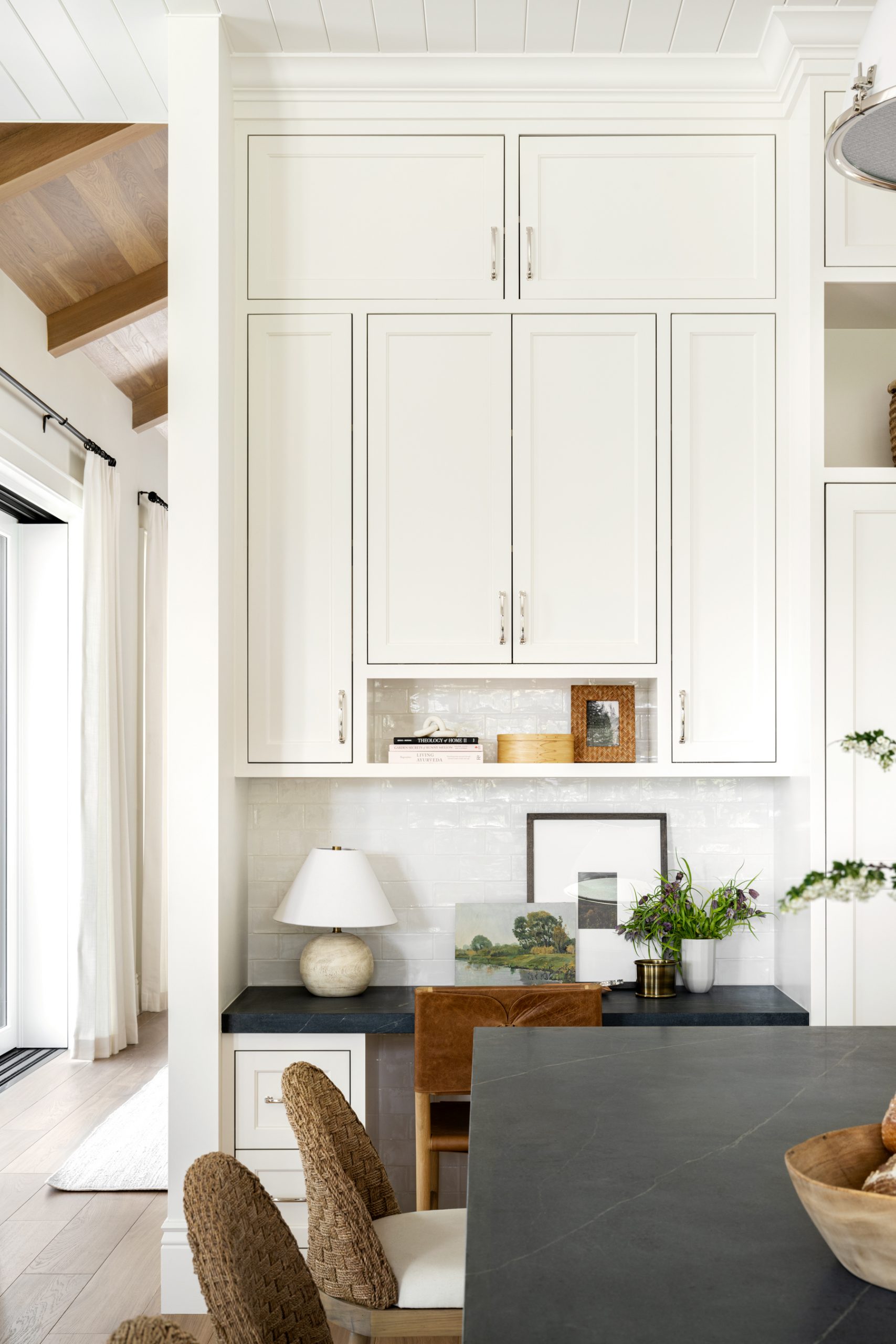 white kitchen with dark countertops and wood accents