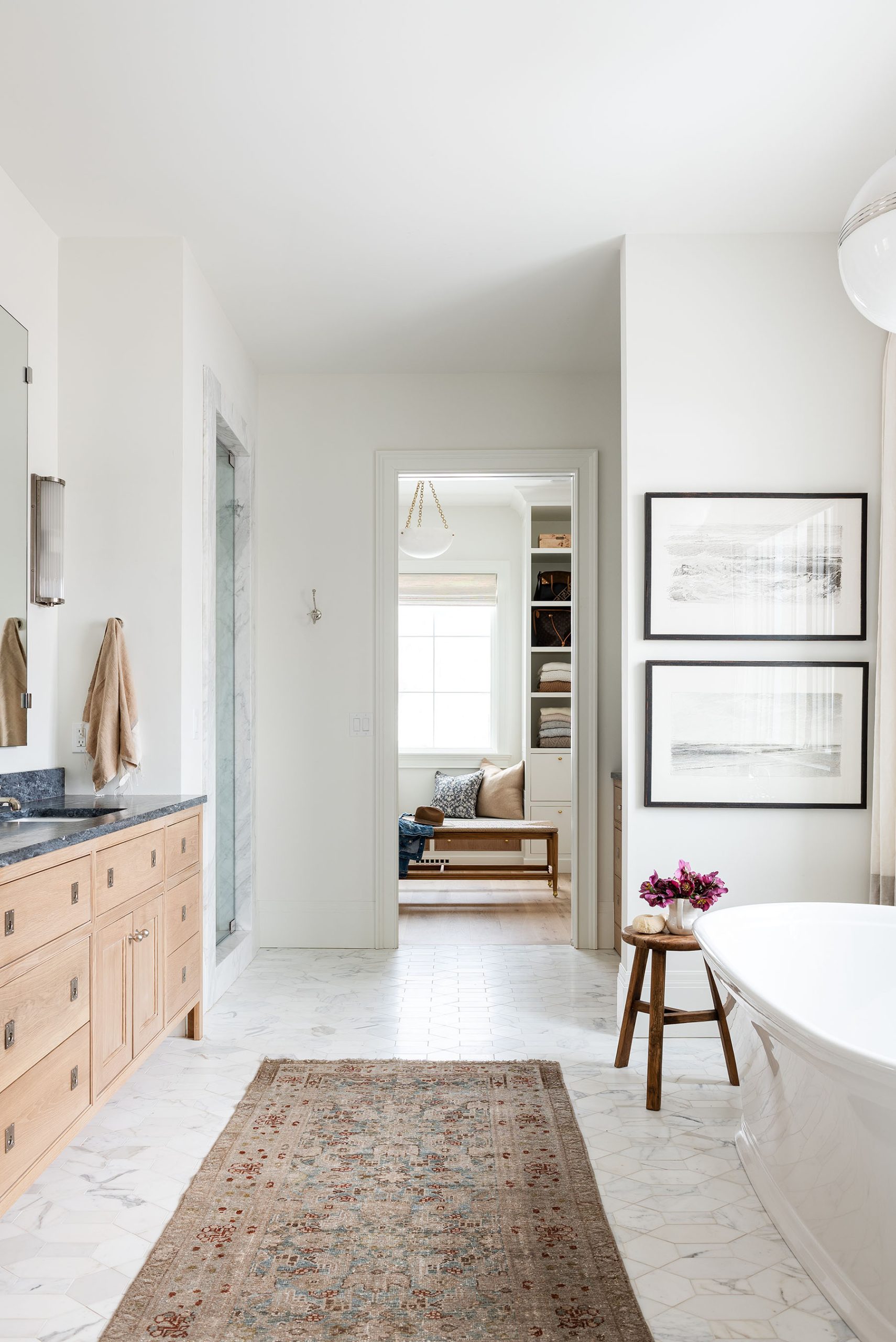 bathroom with wood cabinets and white bathtub
