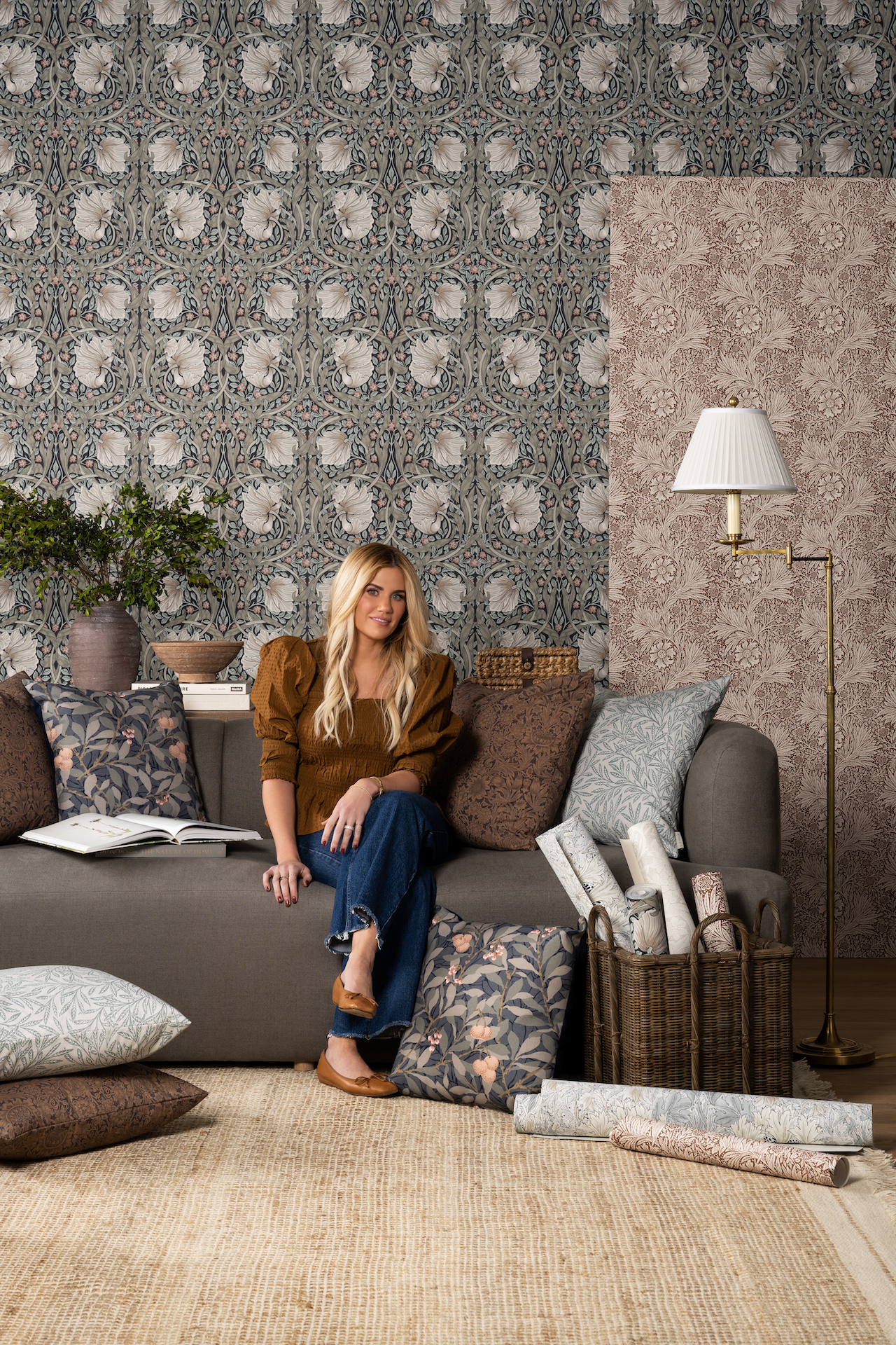 Shea sitting on sofa with Morris & Co. x McGee & Co. wallpaper and pillows