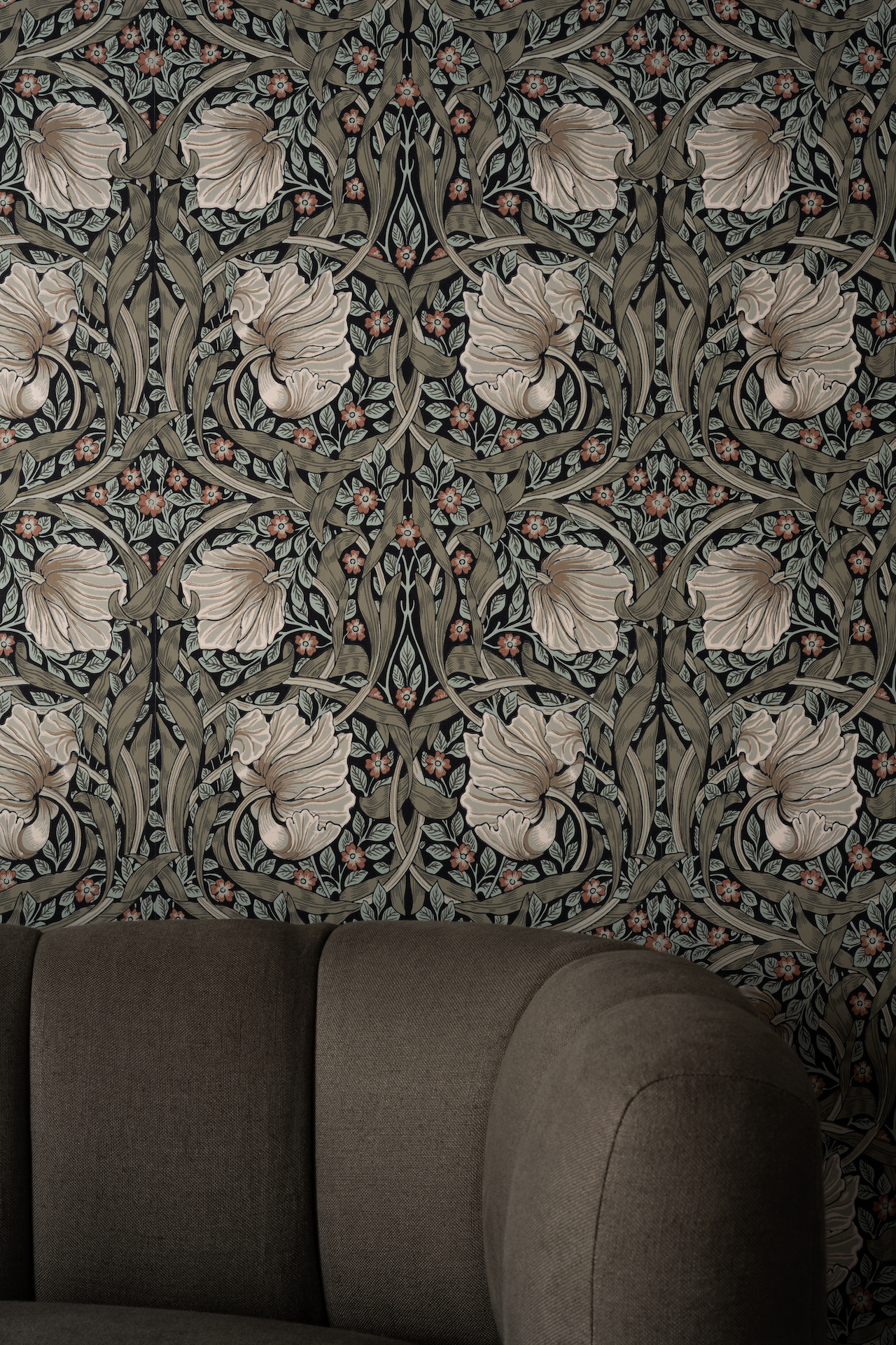 sofa in front of floral wallpaper