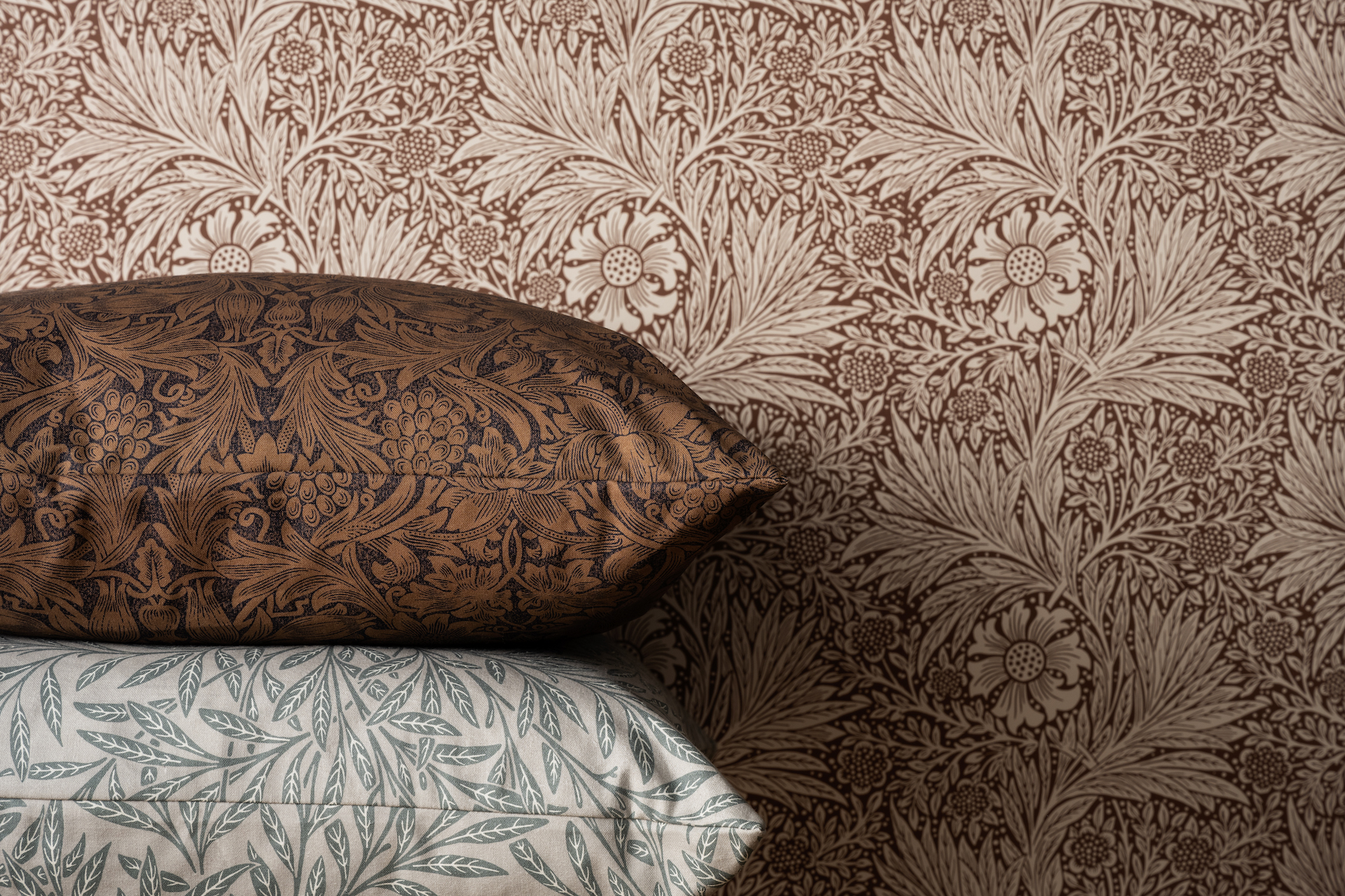 red toned floral wallpaper with stacked pillows