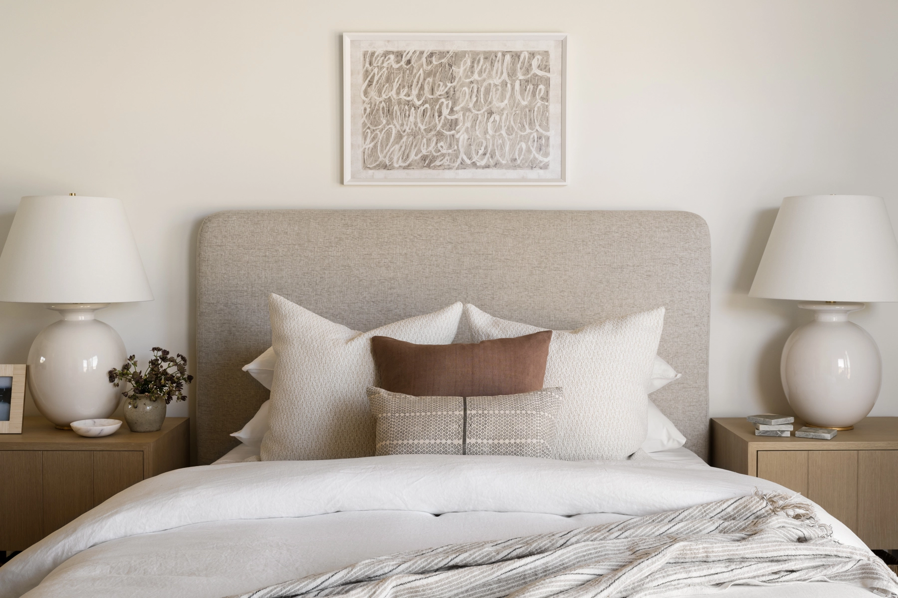 upholstered gray bed with wooden nightstand