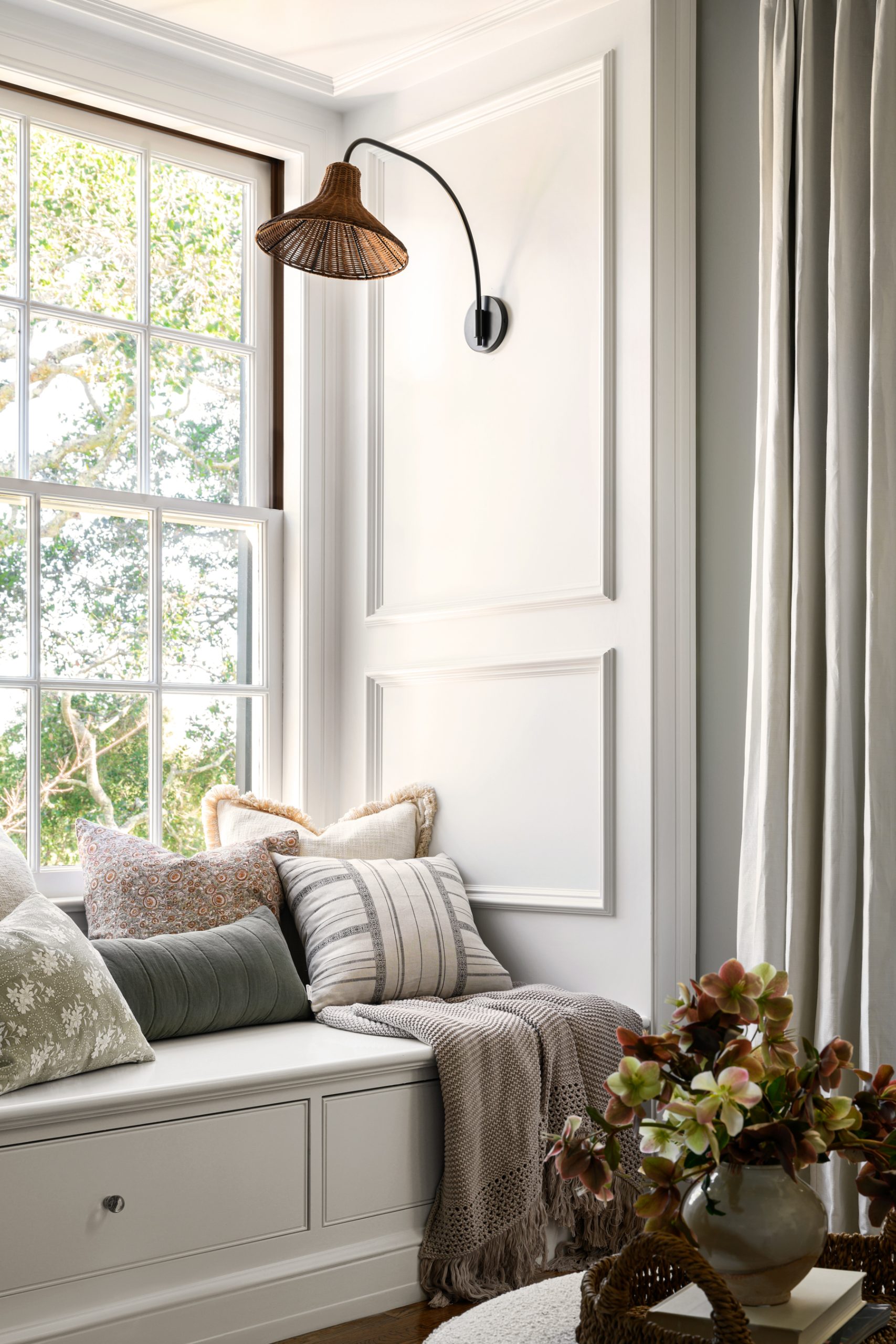 window nook with pillows and sconce