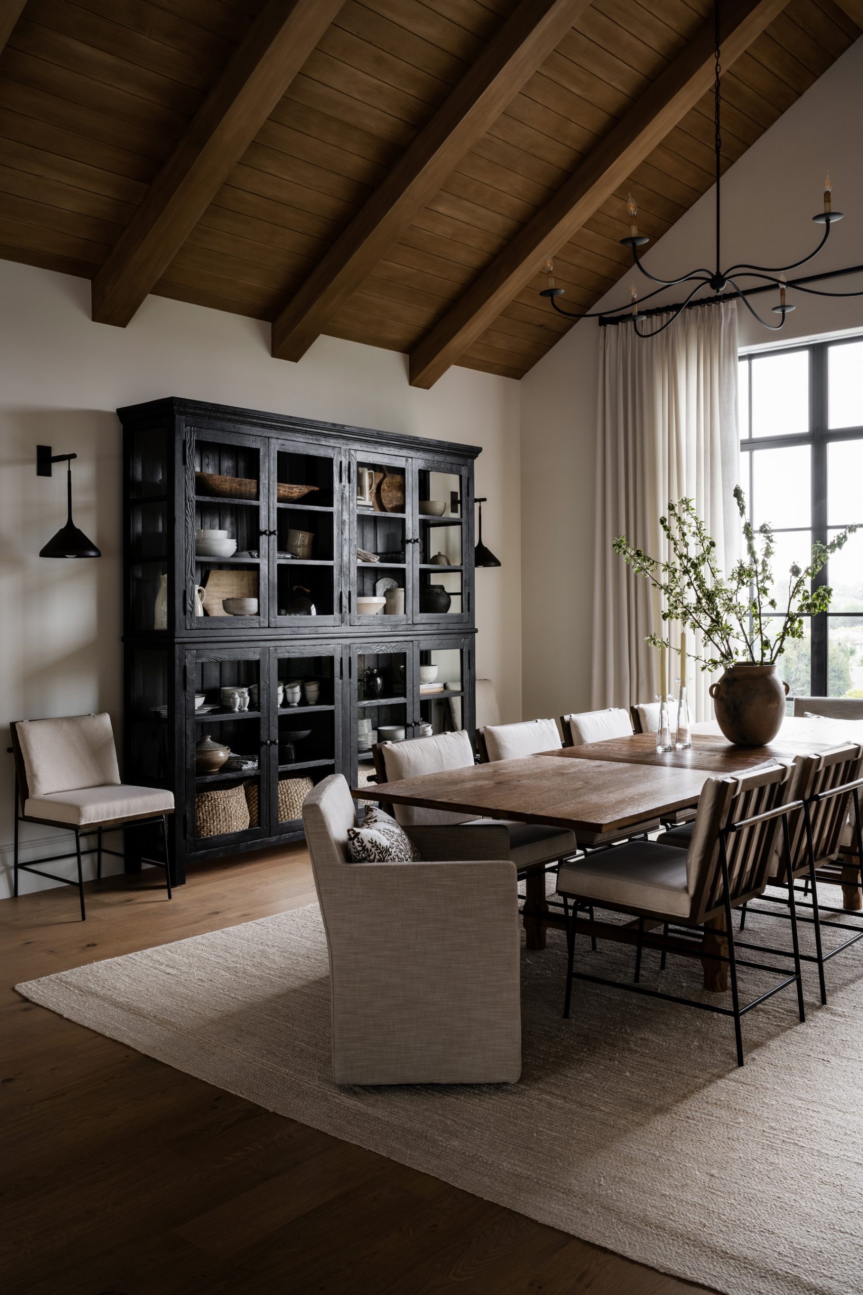 dining room with black hutch with vintage dough bowl