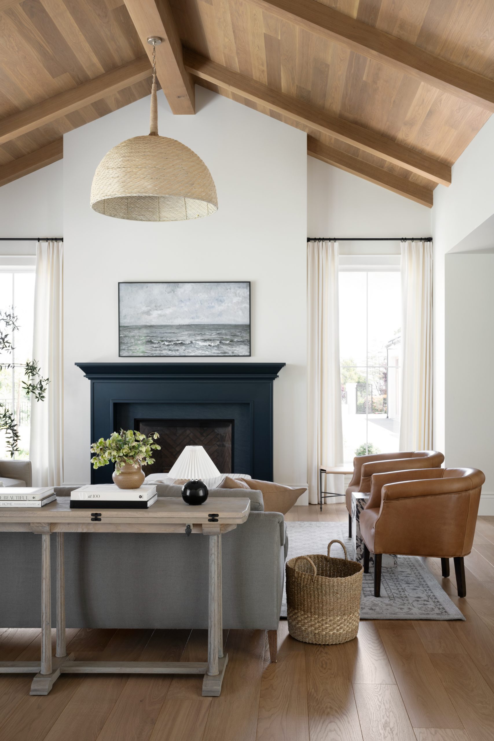Coastal living room with gray sofas and leather chairs with pendant