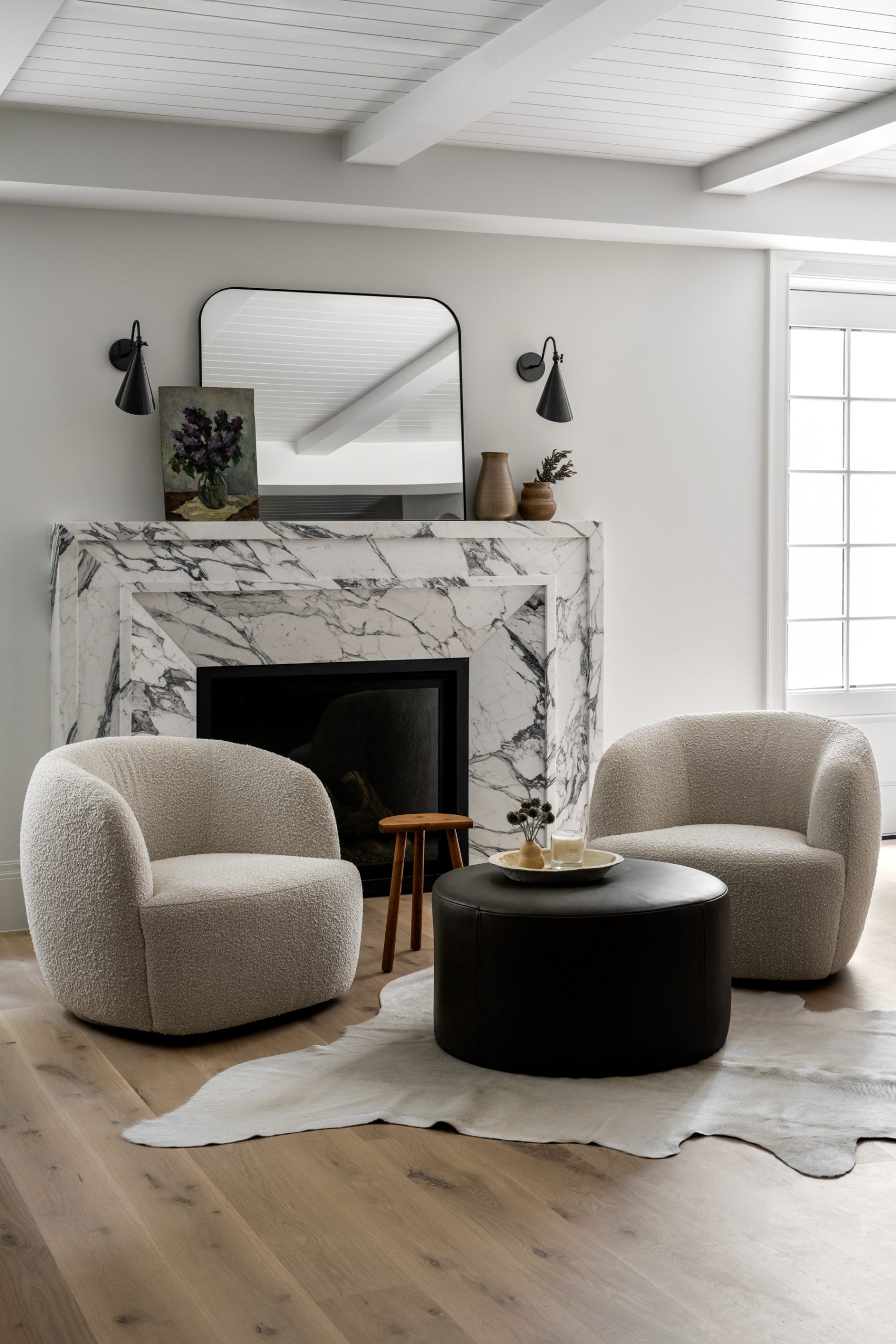 Marble fireplace with two lounge chairs in front