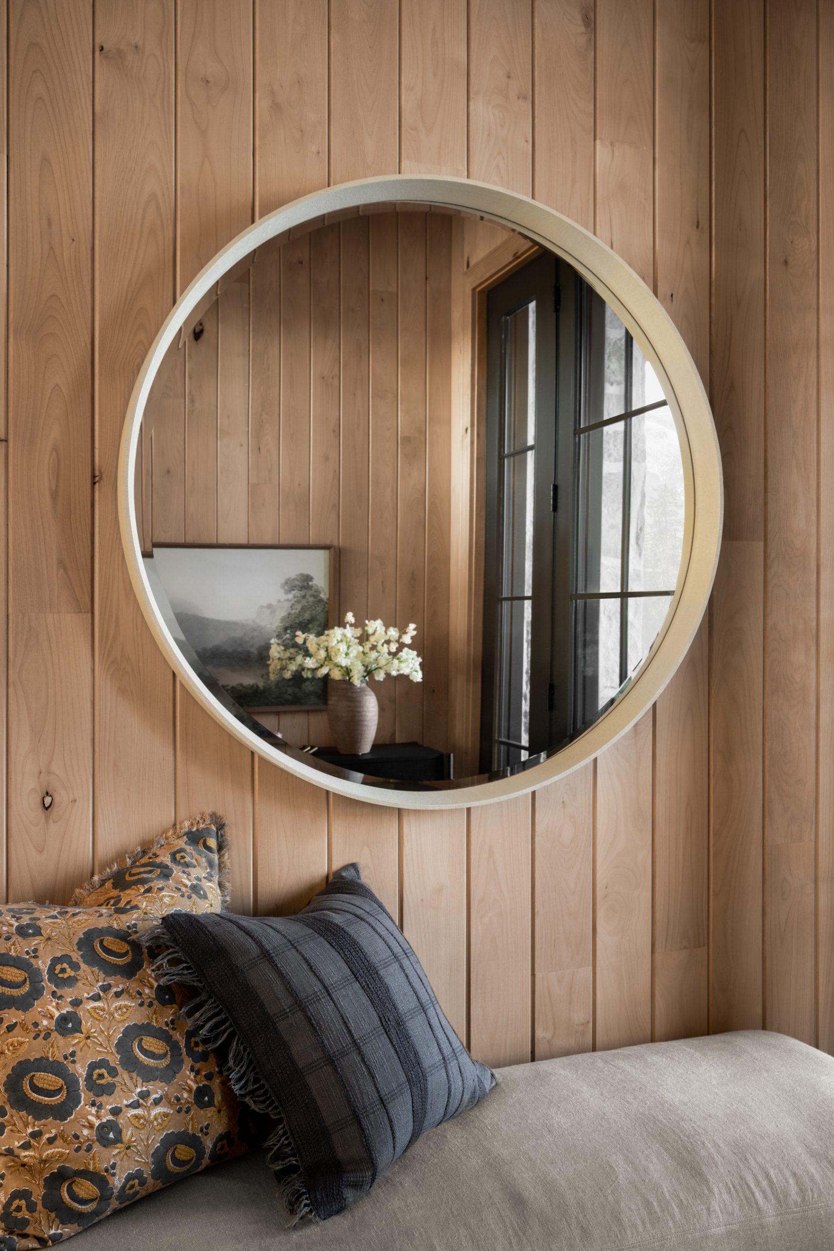 bench with round mirror in entryway