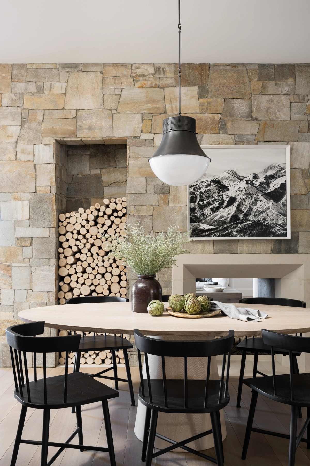 dining area with stone fireplace and cut out with wood logs