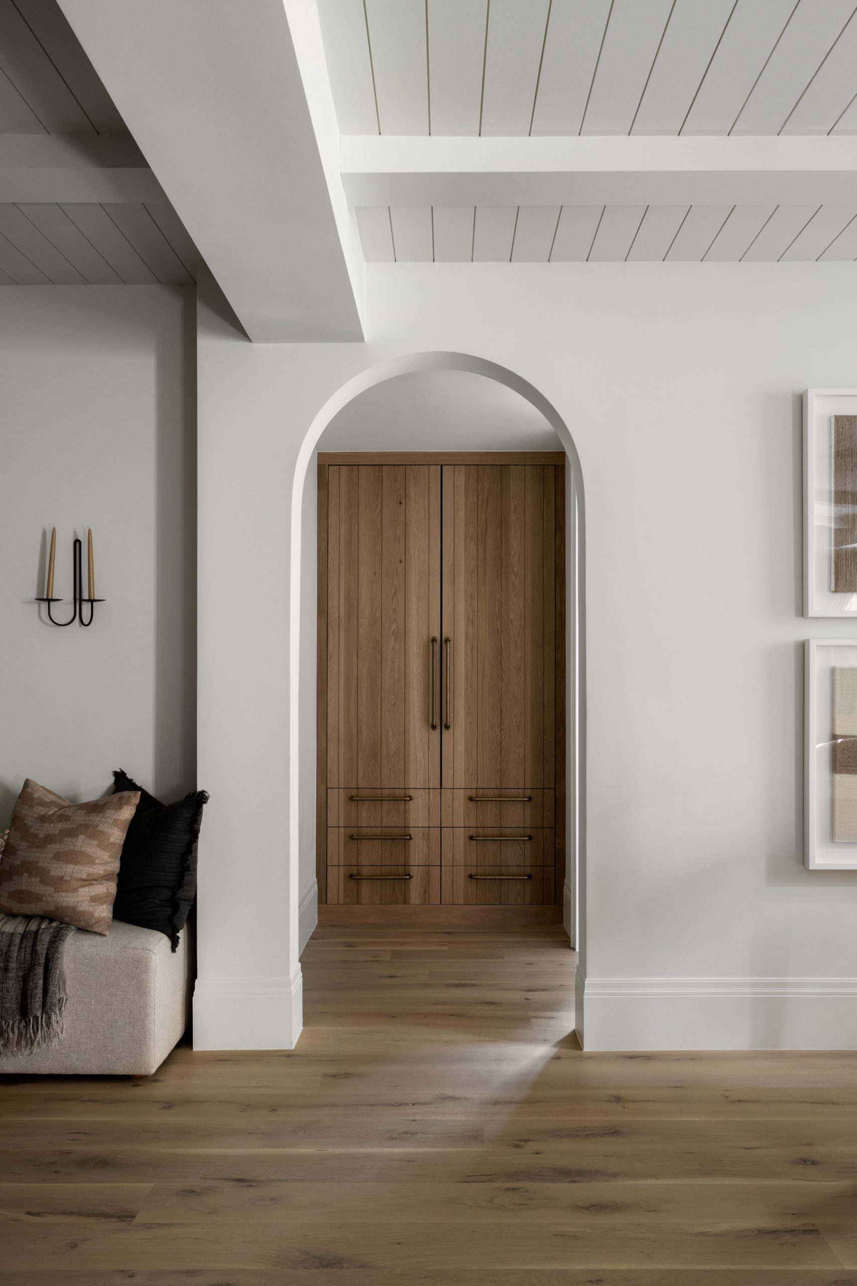 arched doorway leading to wood built-in cabinet doors