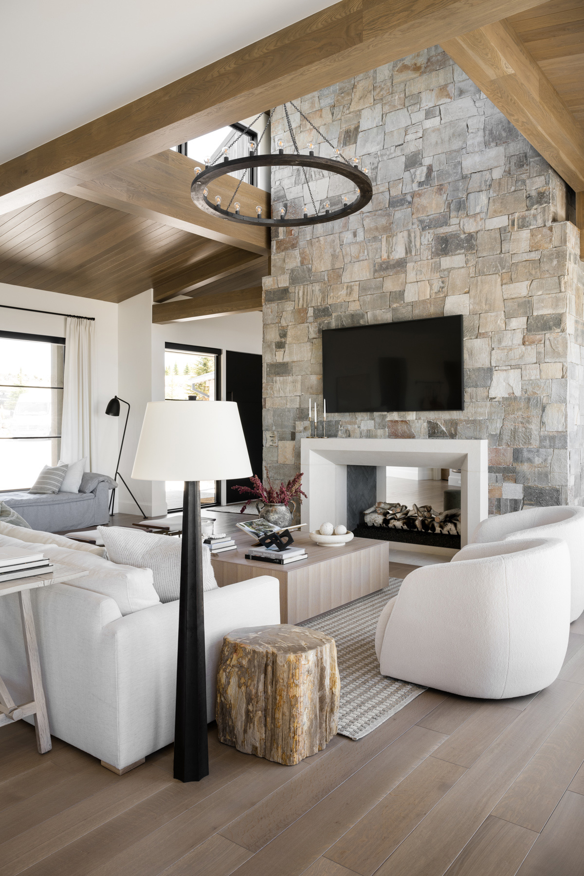 living room with stone fireplace and wood side table