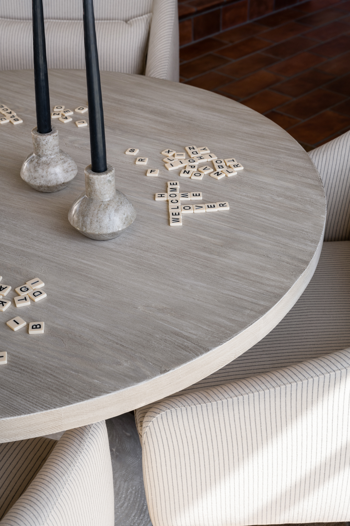 living room with round game table with scrabble