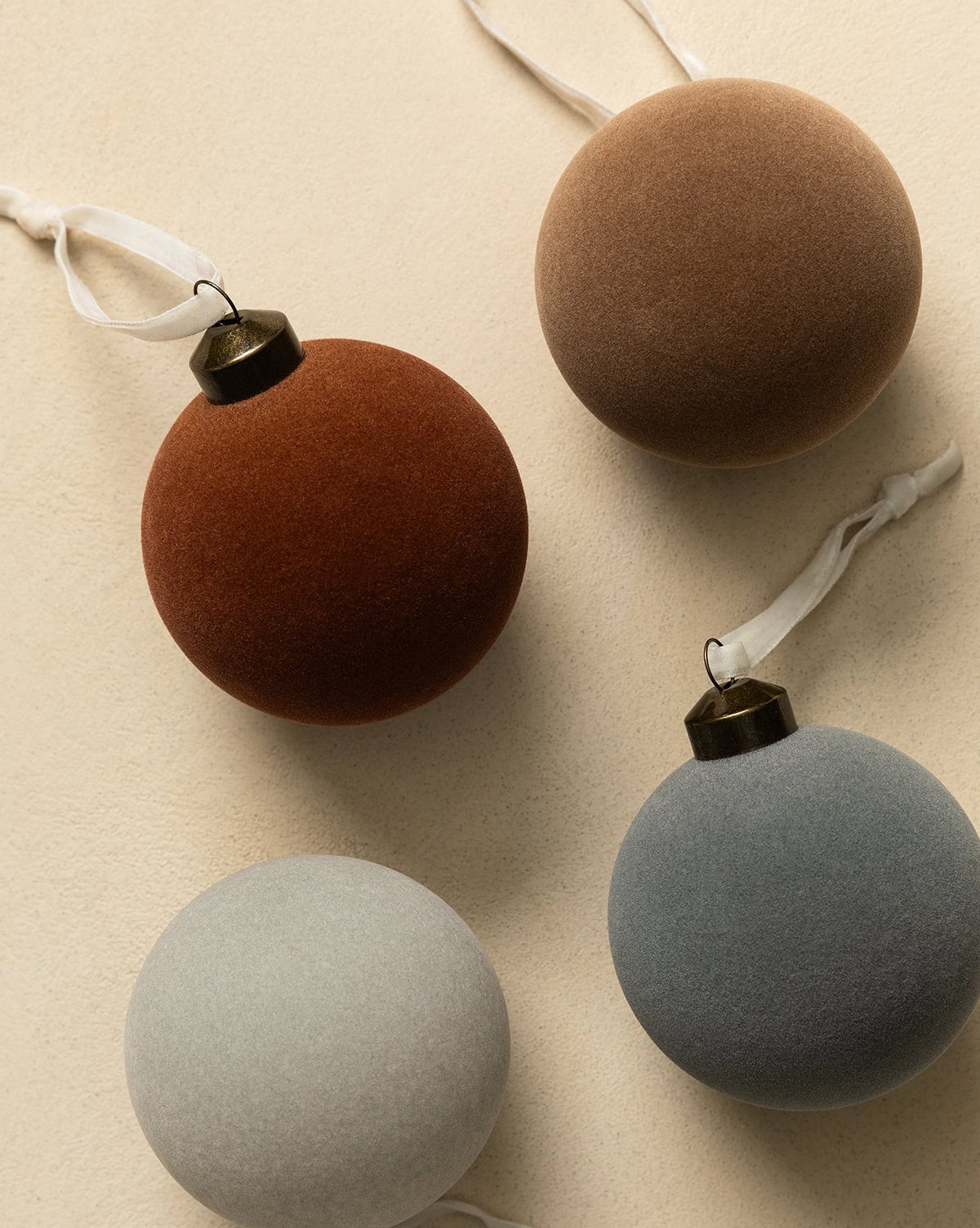 Assorted flocked baubles in earthen colors, matte finish ornaments from Studio McGee.