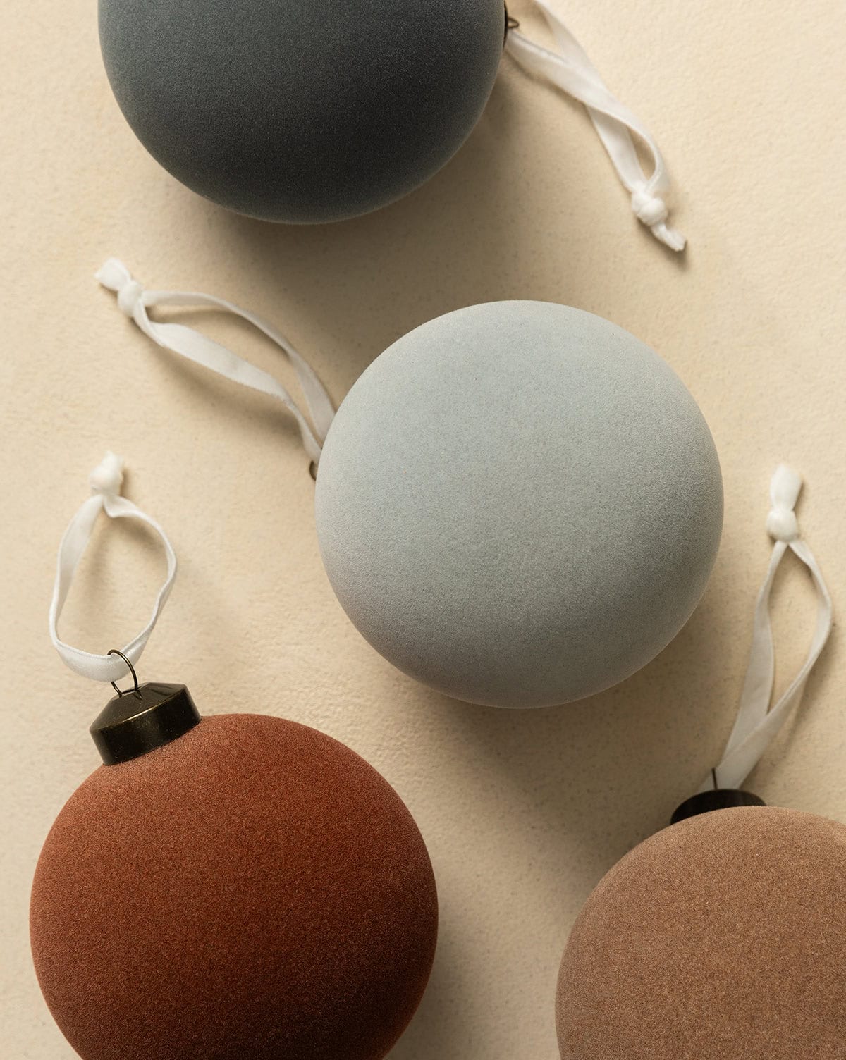 Large 4" assorted matte color finished bauble tree ornaments in green, rust, tan and grey with white ribbons from Studio McGee.