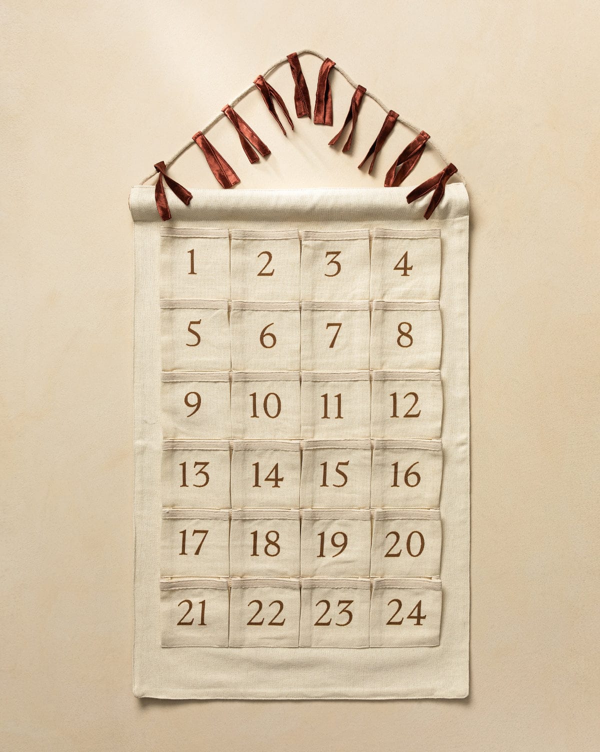 Countdown the days to Christmas Eve with this custom advent calendar designed with cream-colored cotton linen piece and 24 numbered pockets from Studio McGee.