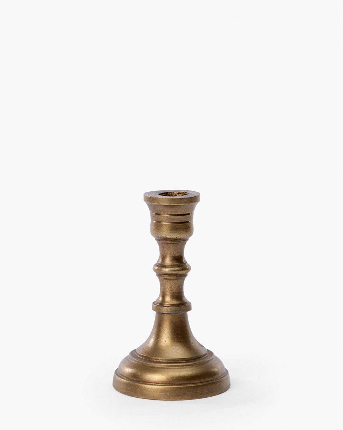 Aged brass finish taper candle holder for mantle and tabletop decor seen on Studio McGee.