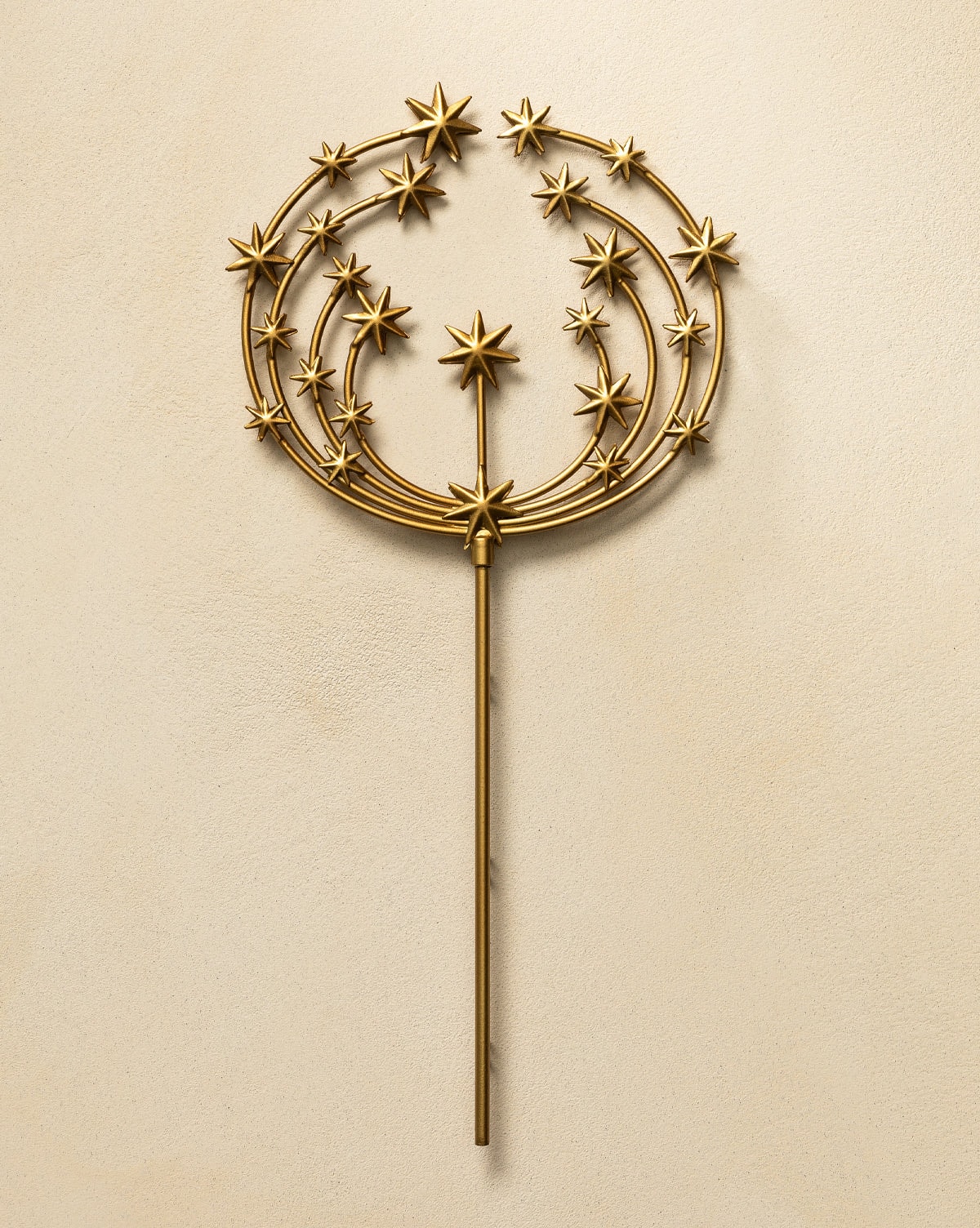 A beautiful starry tree topper designed an antique brass finish, will elegantly crown holiday Christmas trees from Studio McGee.